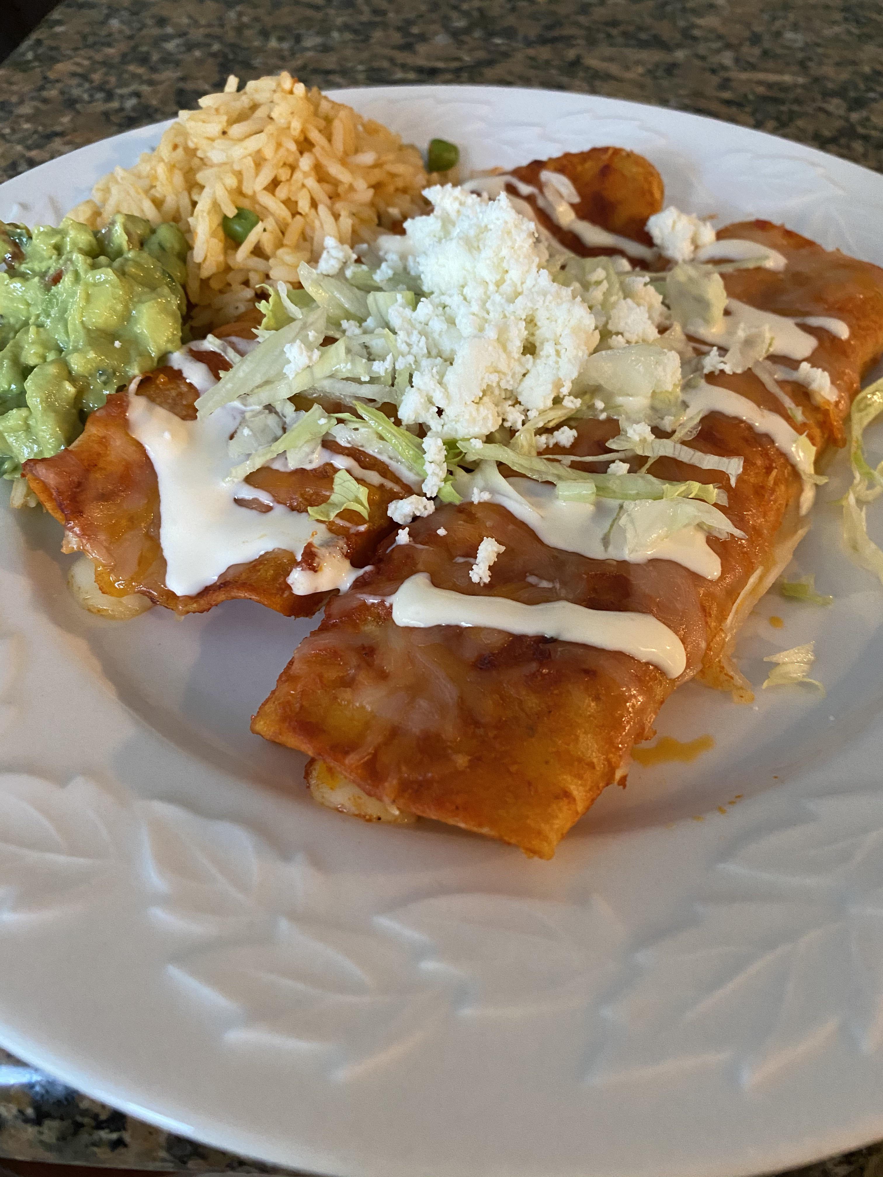 Chile de árbol enchiladas topped with crema and Cotija cheese. Side of