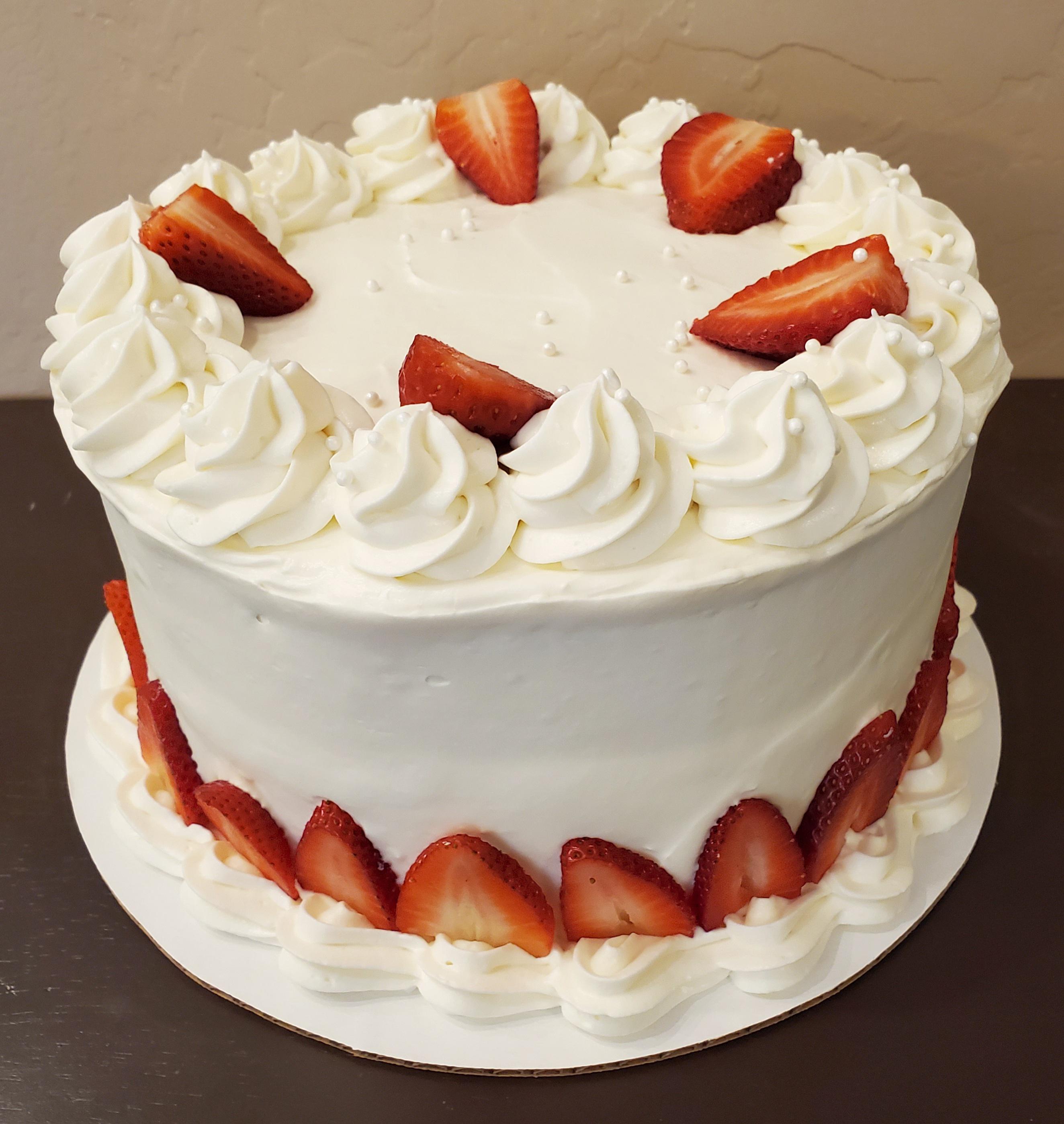 French vanilla cake with whipped cream cheese frosting and strawberry