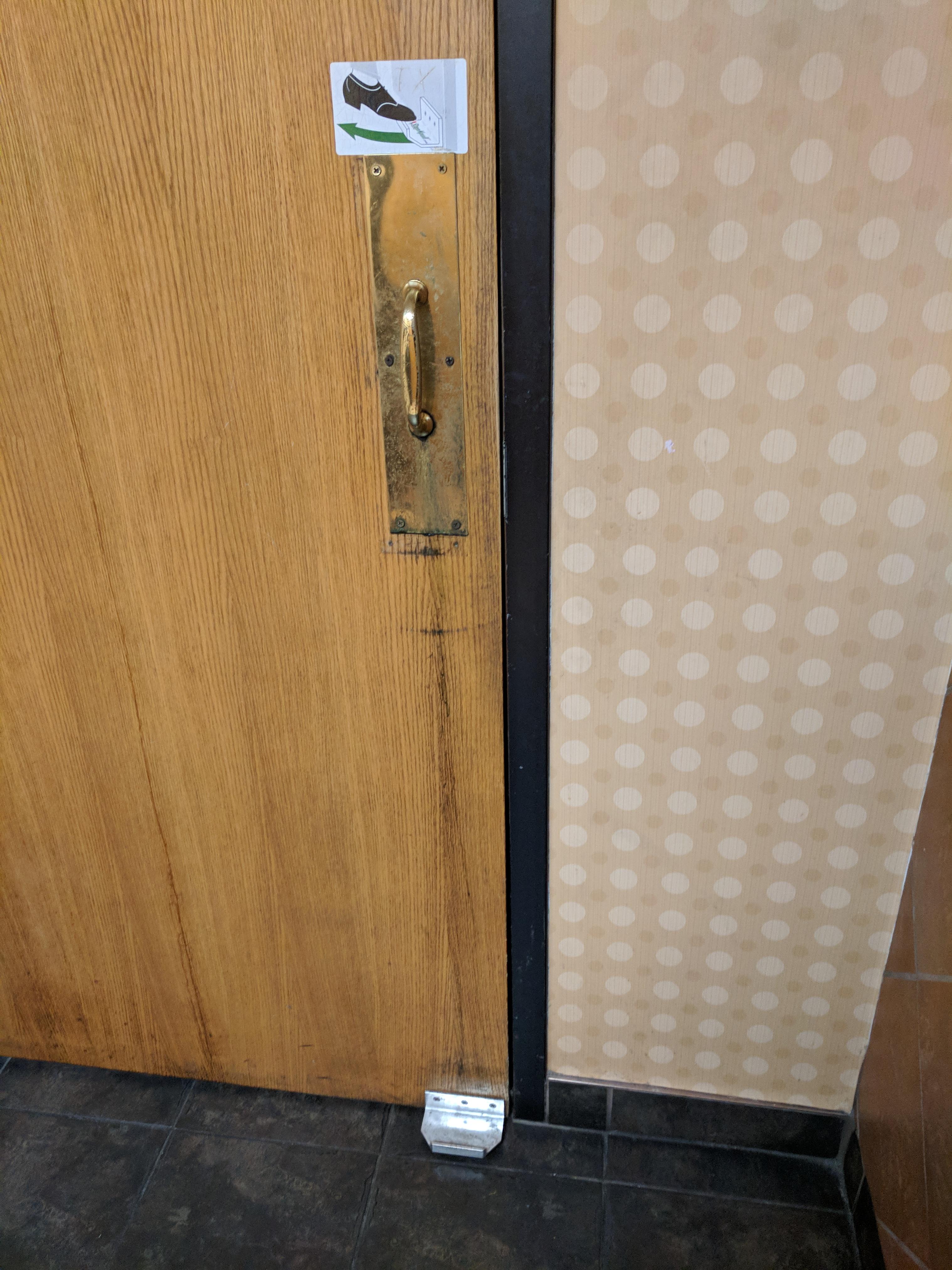 This bathroom door has a foot handle so you don't have to use your