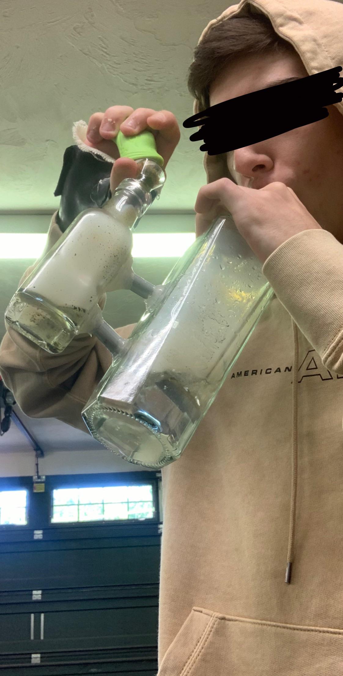 Homemade bottle bong with ashcatcher out of an empty Pink Whitney, a