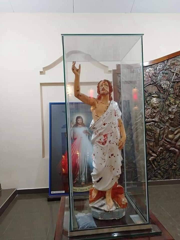 Blood splattered statue of Jesus Christ. Aftermath of the Easter Sunday