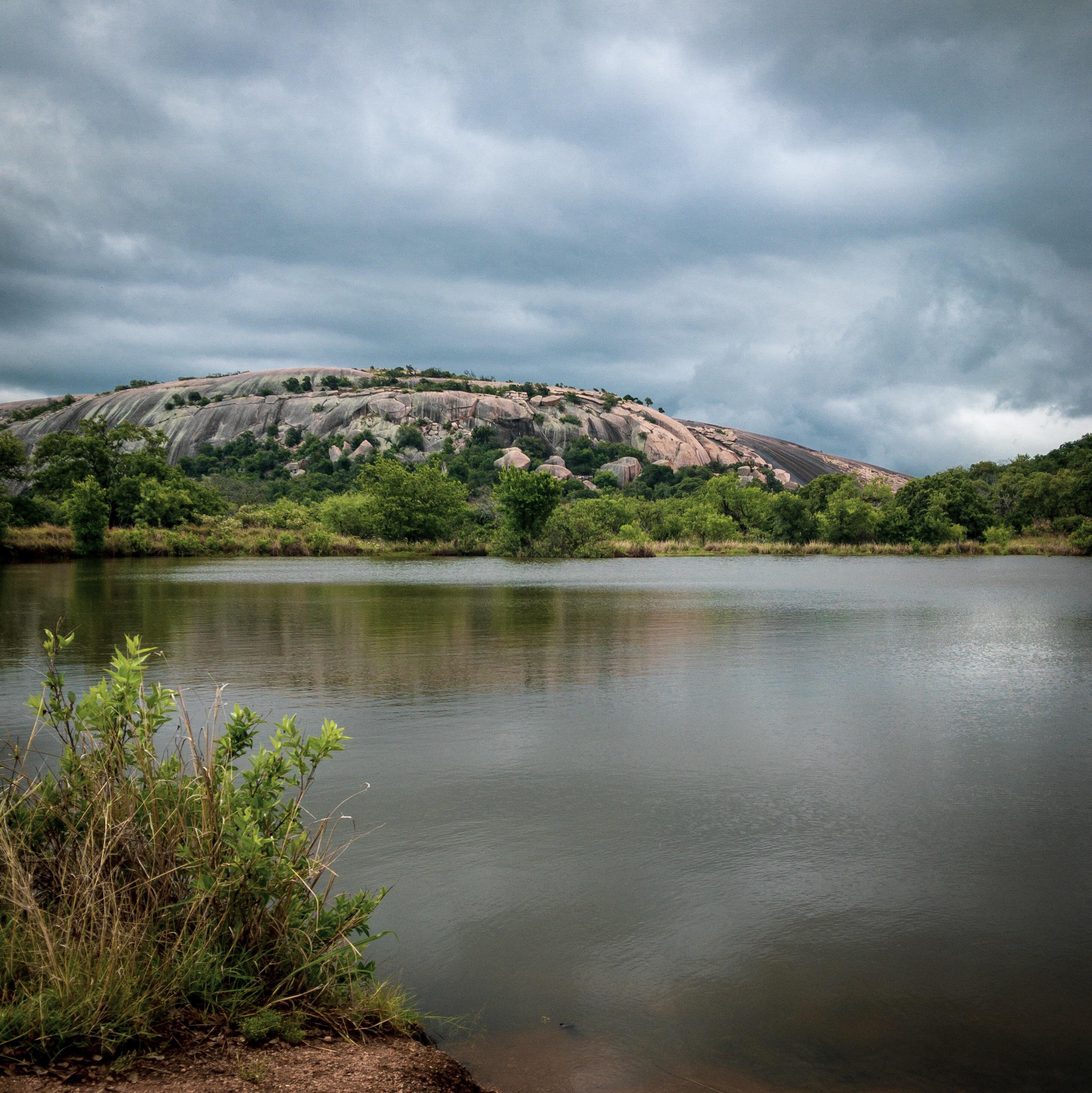 Enchanted Rock over Moss Lake on a rainy morning in mid May r/TexasViews