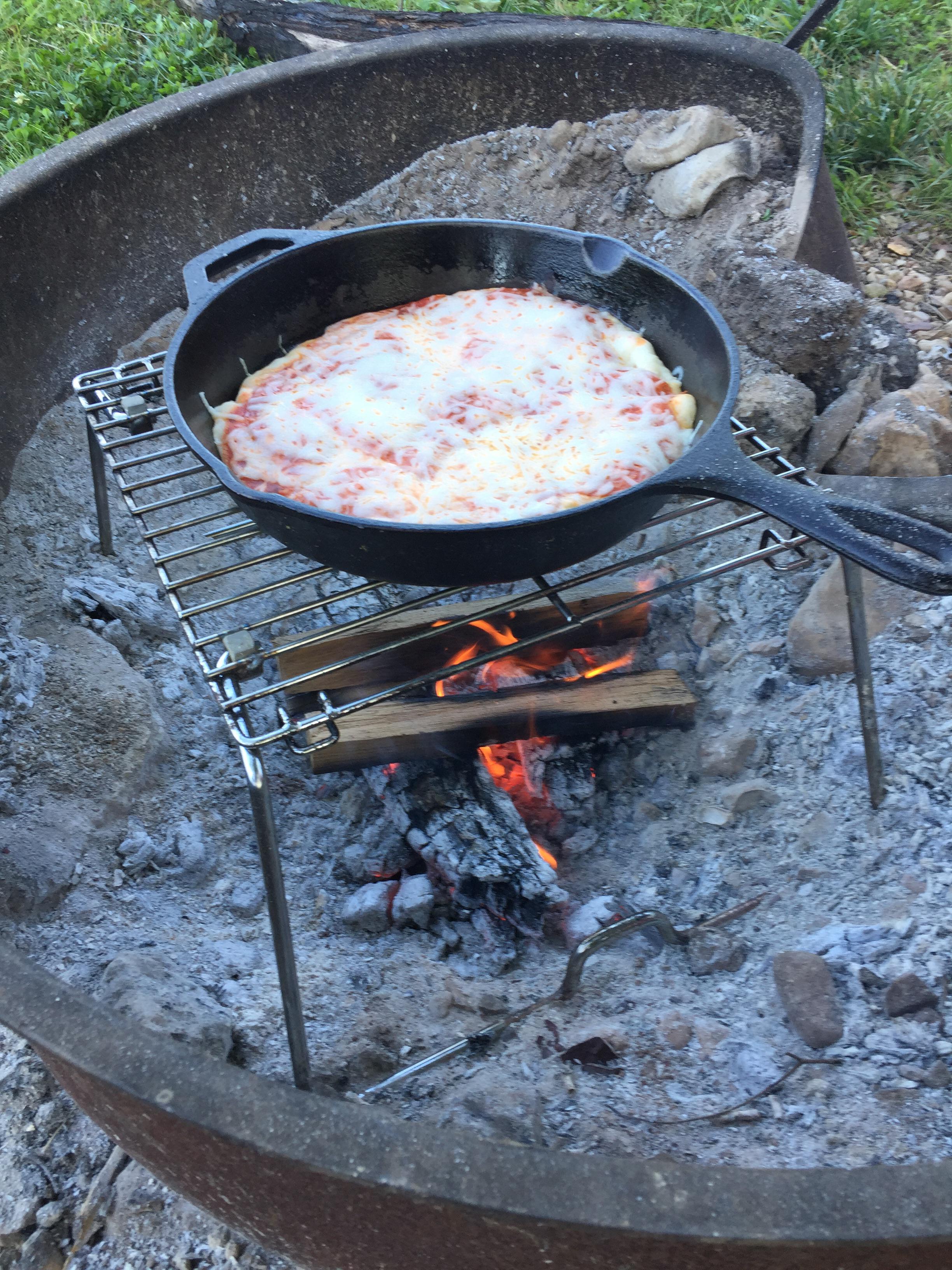 Cast iron pizza quickly became one of our favorite campfire meals for