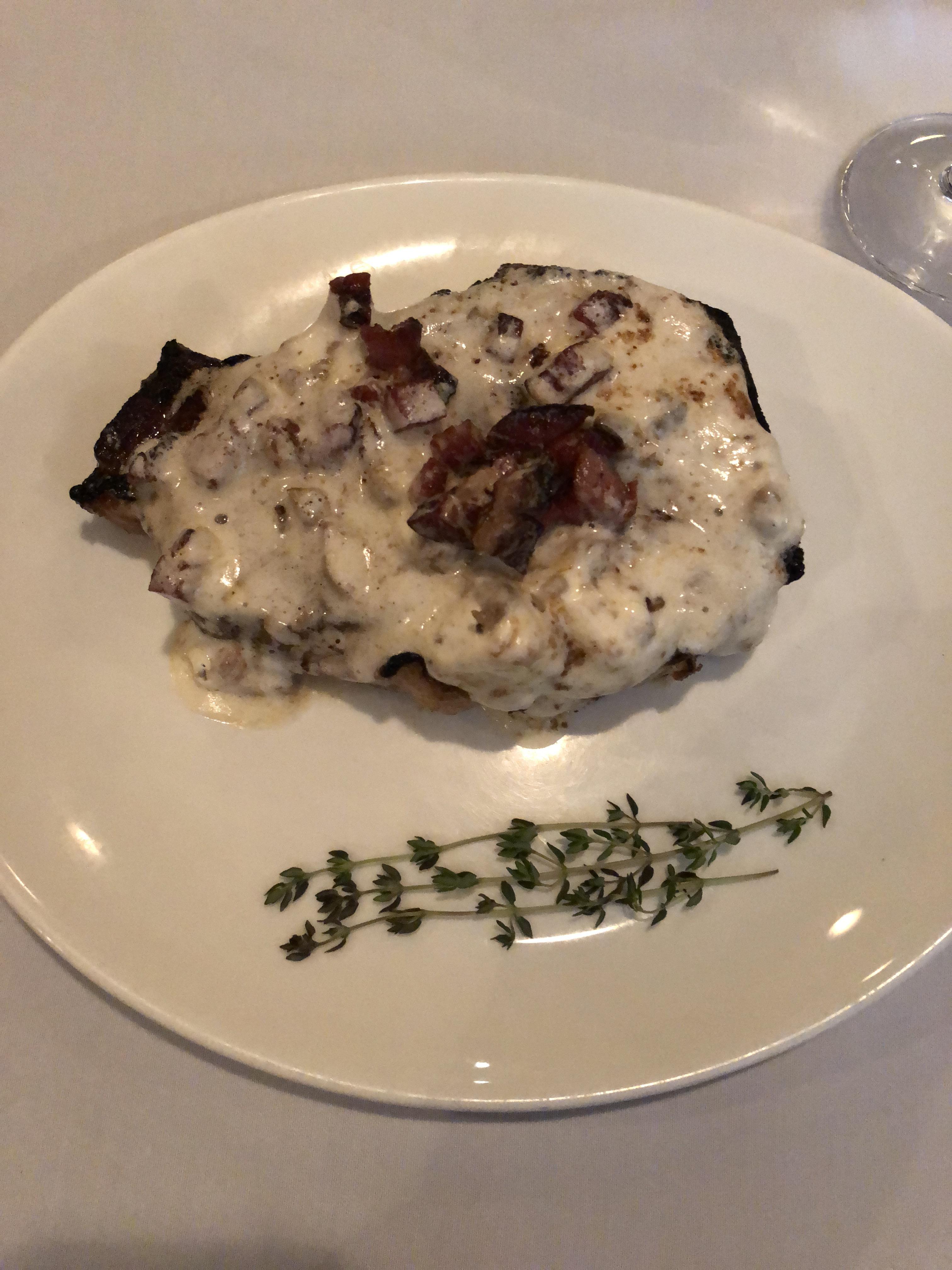 Prime, dry aged Kansas City strip steak, topped with truffle bacon foie