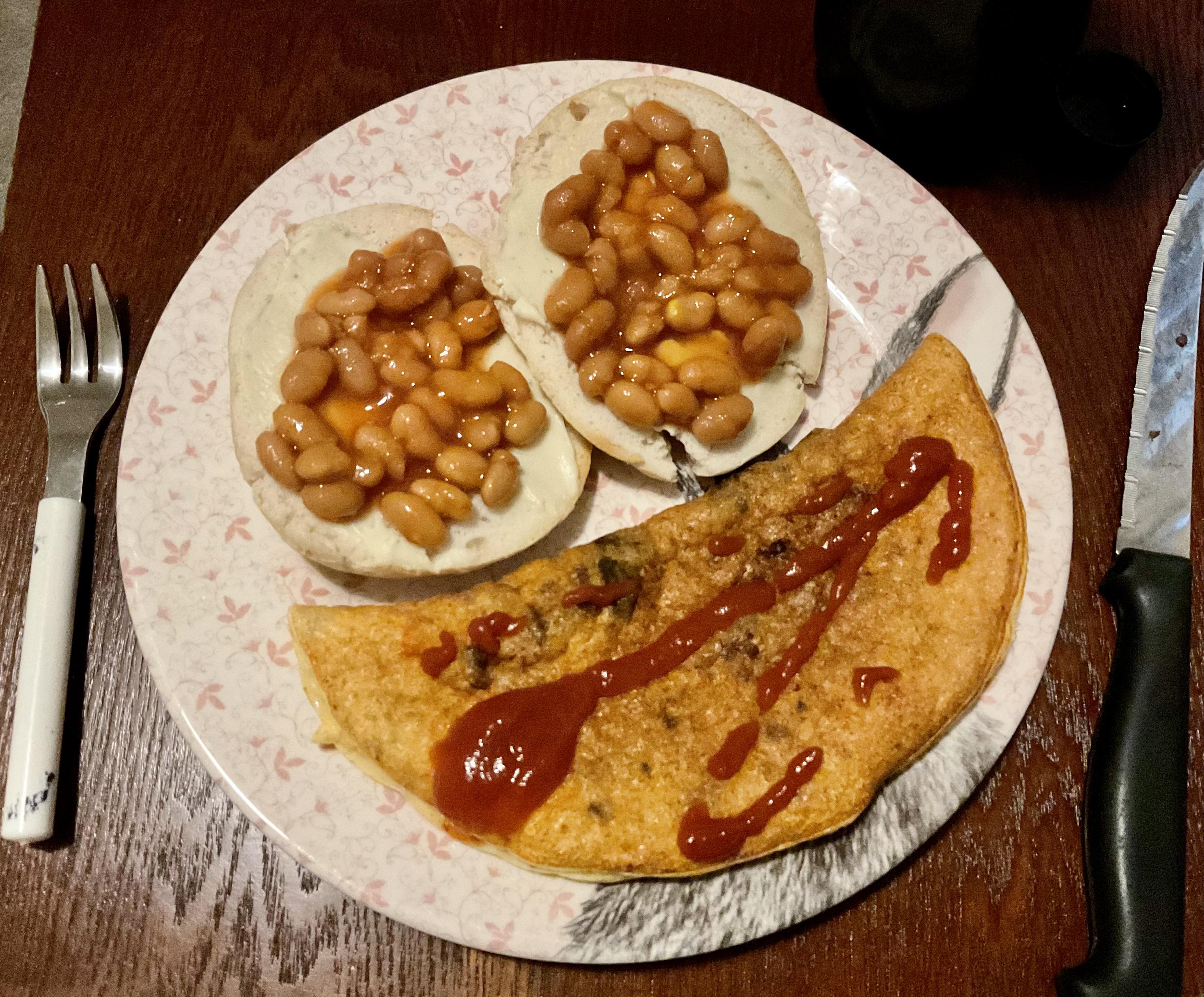 British beans on a laughing cow bagel and a cheddar egg white omelette