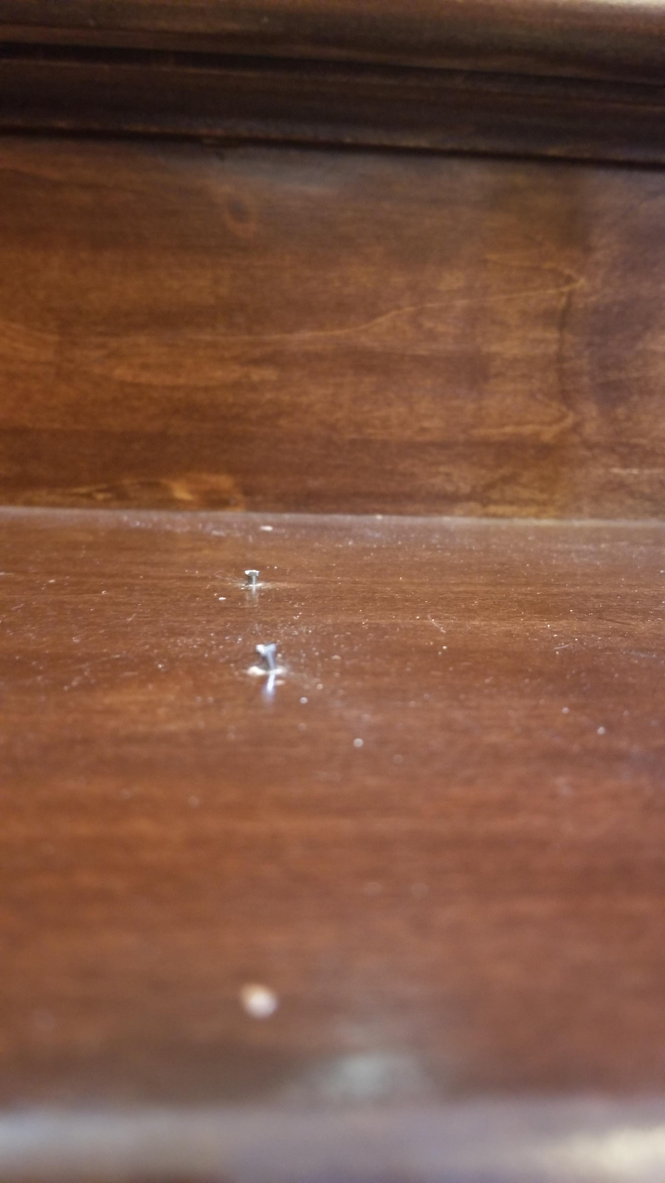 New stairs, center riser nails on treads keep raising up, how do I stop