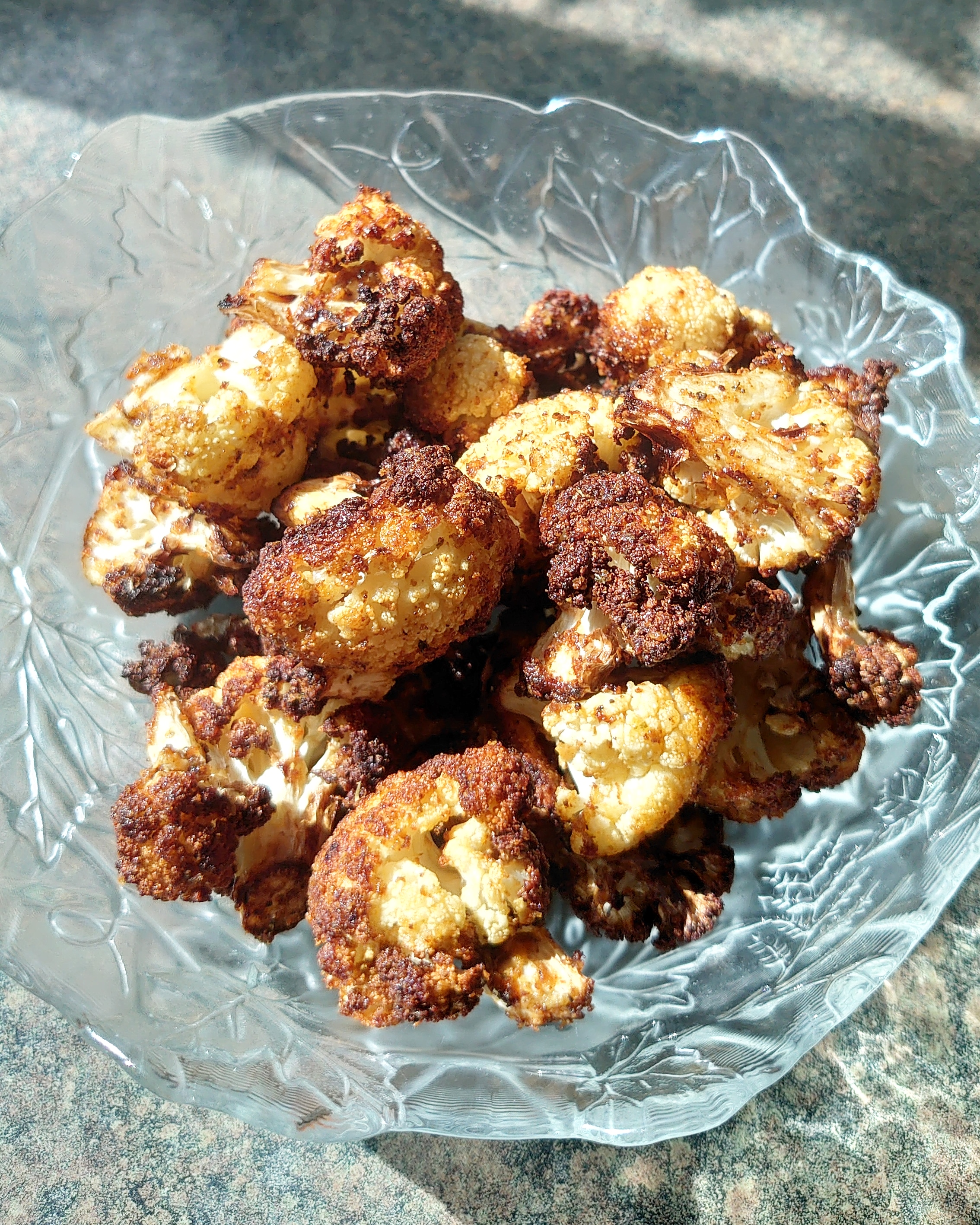 Air fryer cauliflower is where is at. Tossed with chicken salt and 2