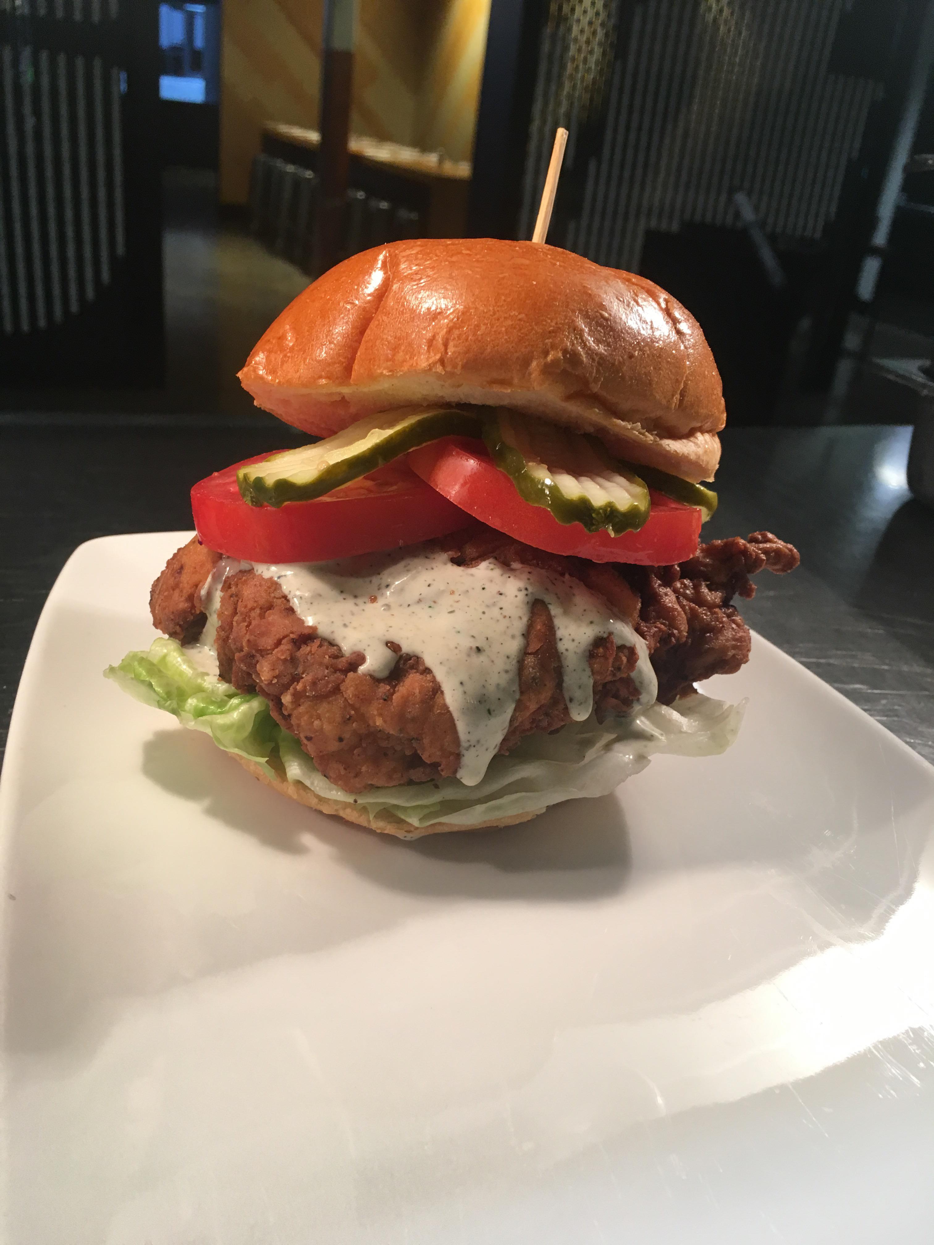 Buttermilk fried chicken sandwich with a black pepper ranch sauce. r