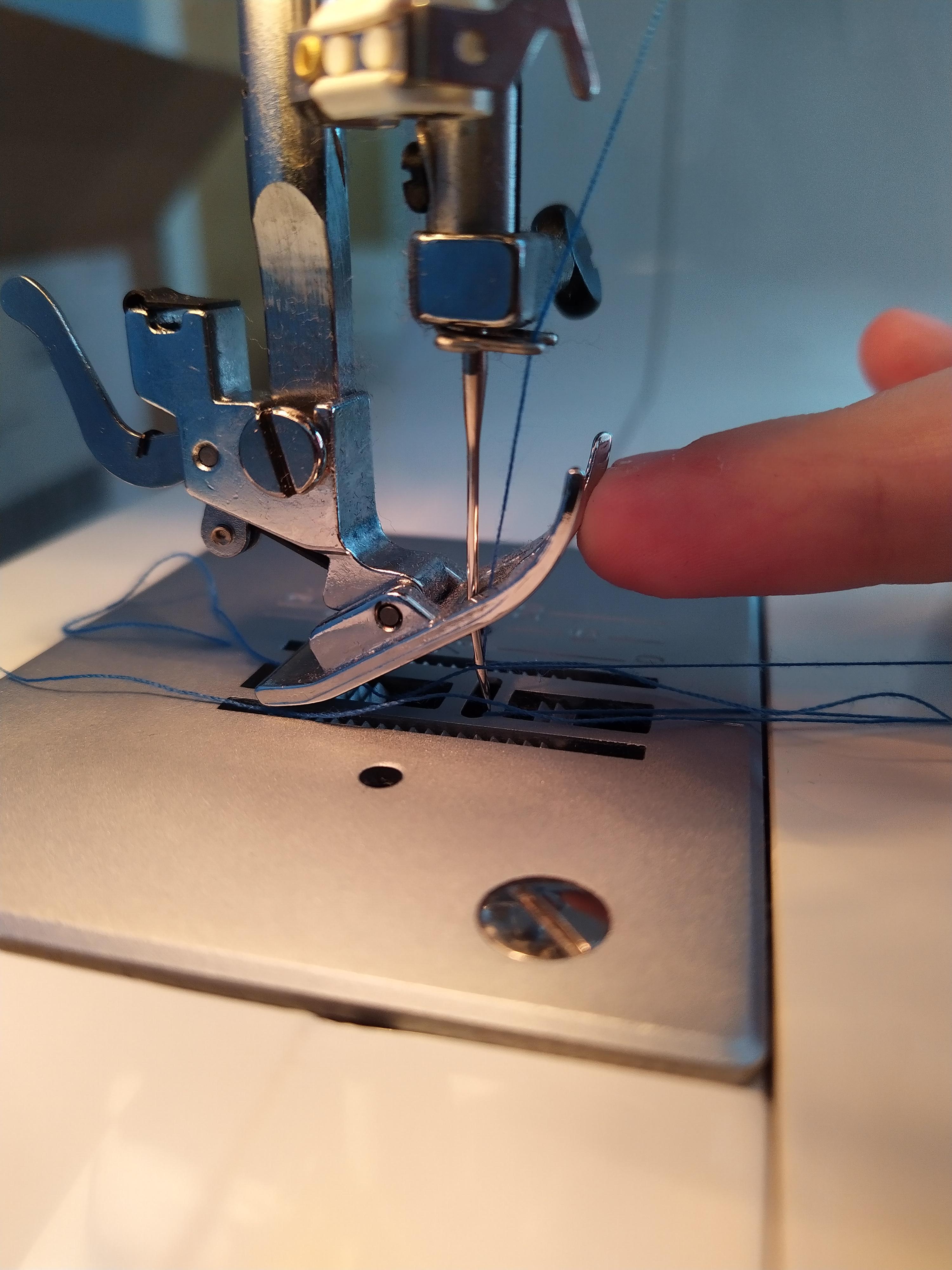 The needle suddenly hit the plate and bent. I heard a metal clang above