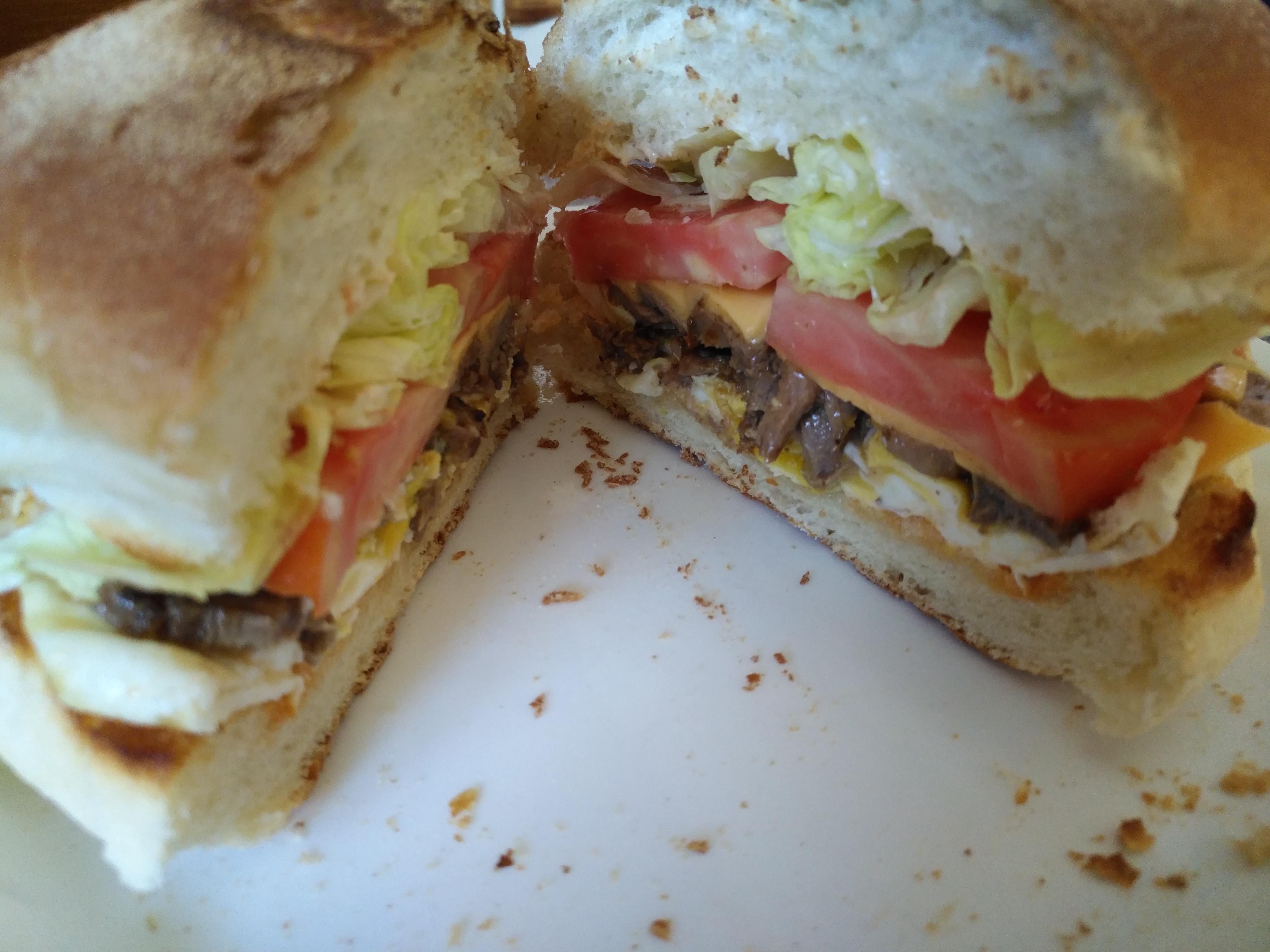 Steak and Egg sandwich. Kaiser bottom, mayo & hot sauce, over medium