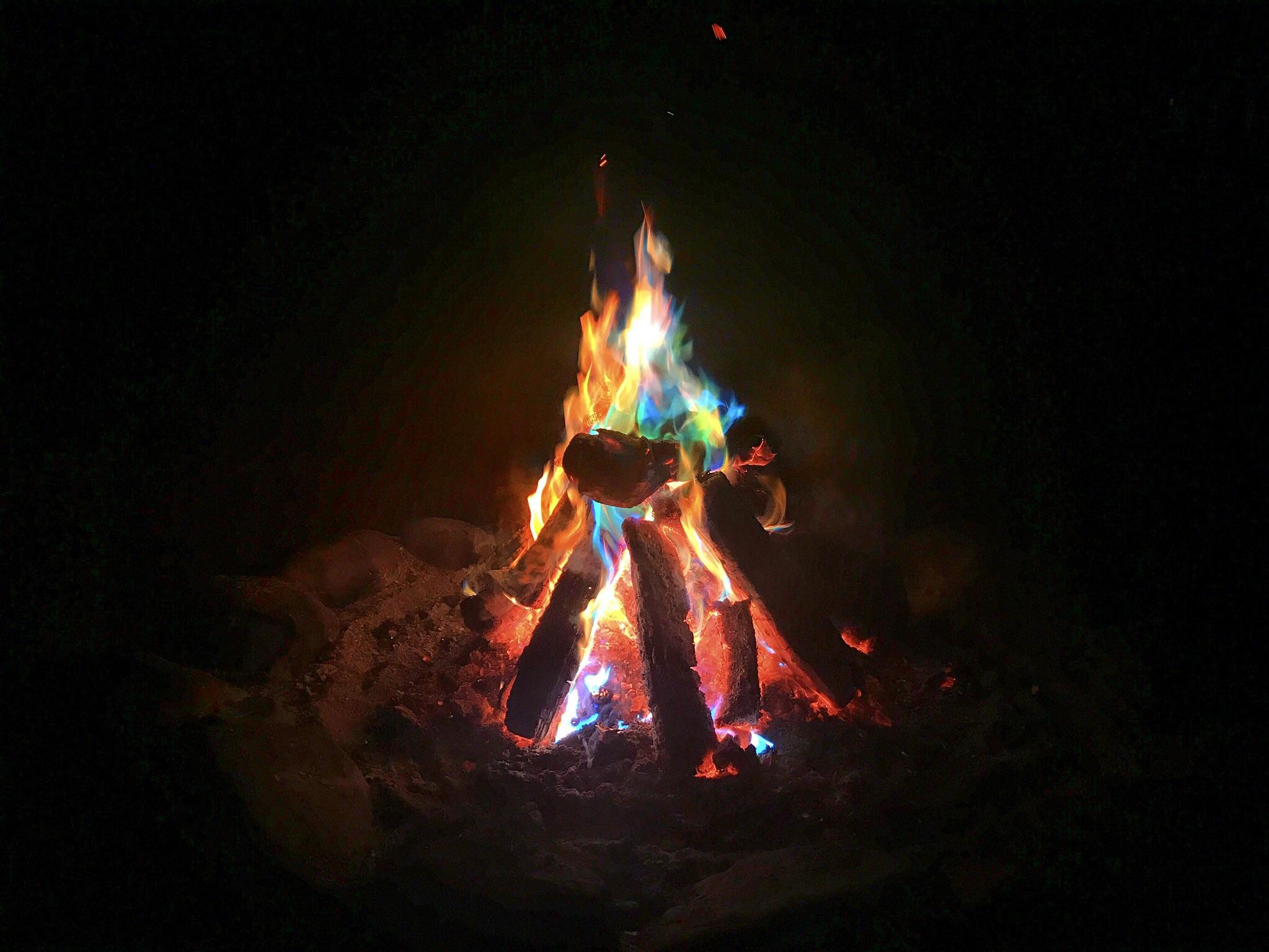 Chemical treated pine cones changed the fires color. A picture I took