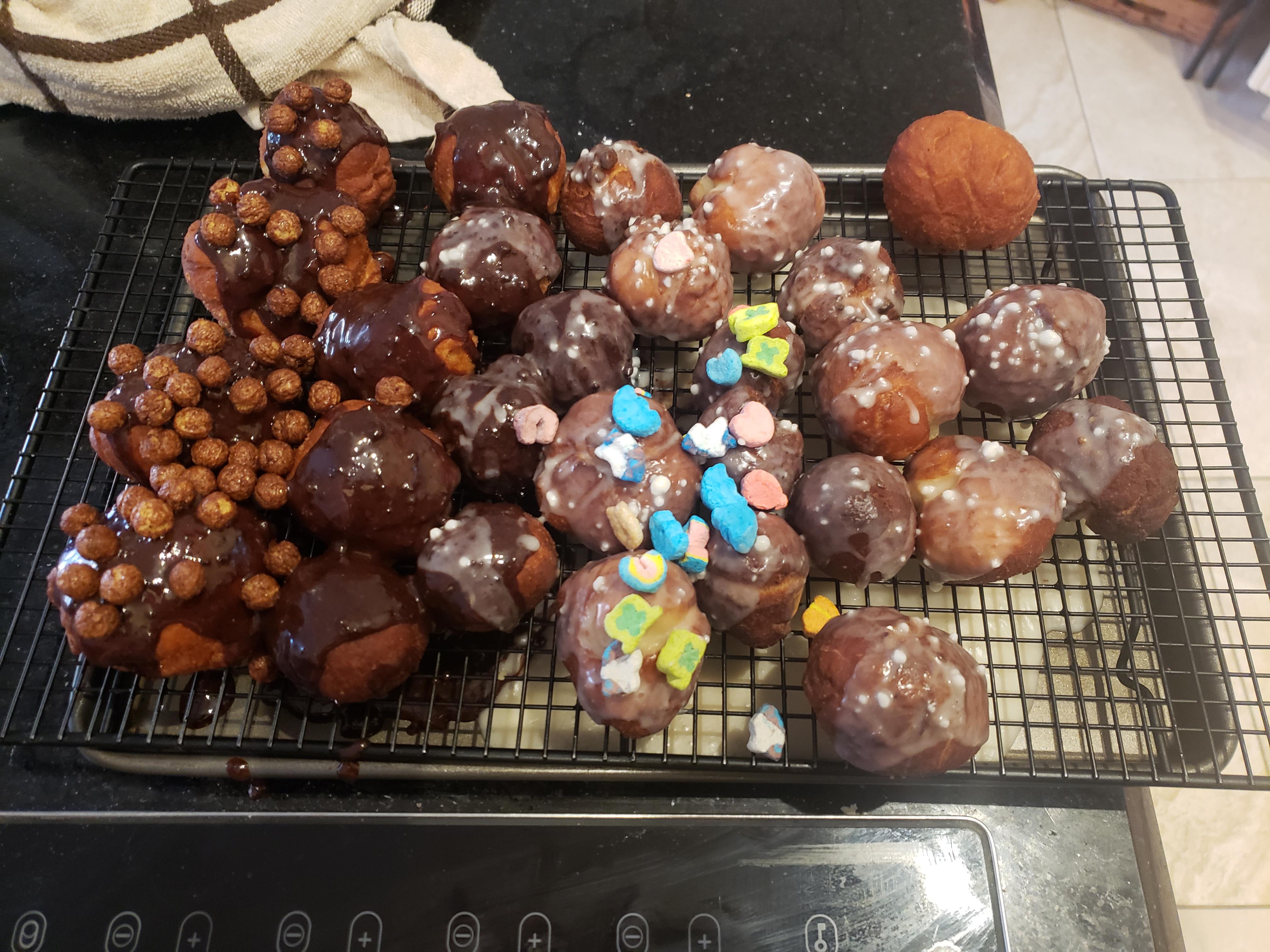 Homemade donut bites with vanilla glaze, chocolate icing, lucky charms
