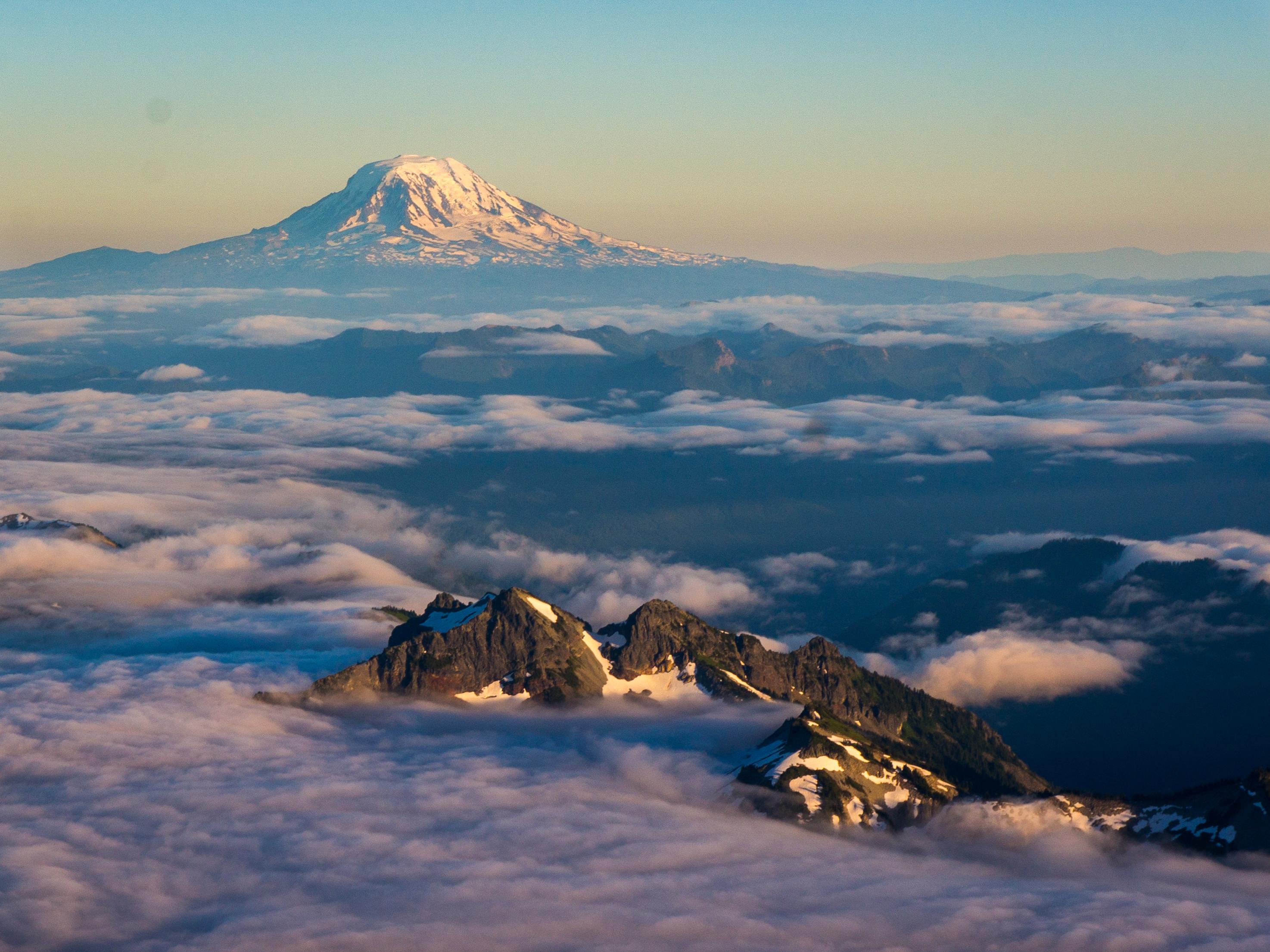Above the clouds on Mount Rainier, with Mount Adams in the background