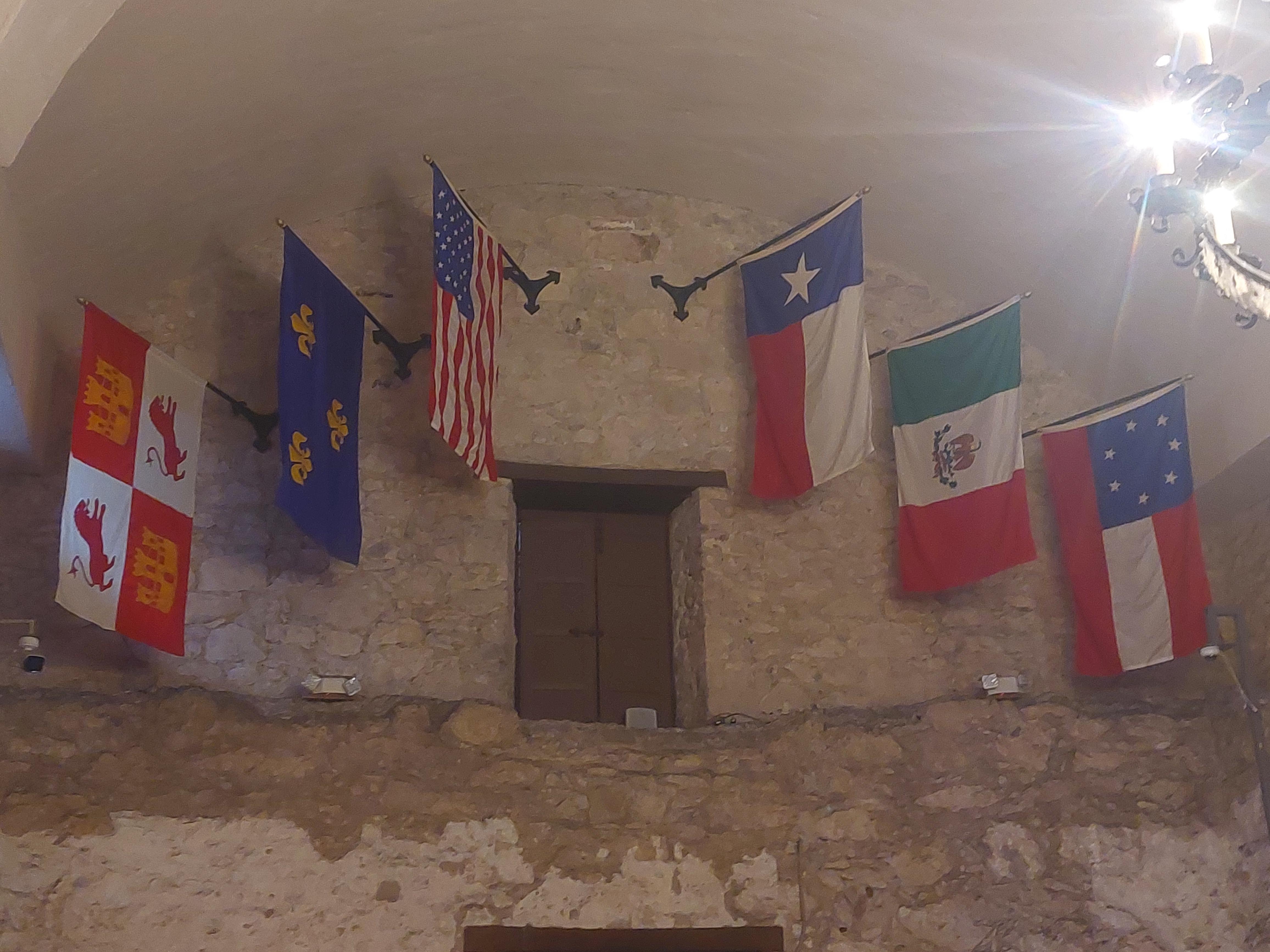 flags flown inside the Alamo mission, representing the six nations to
