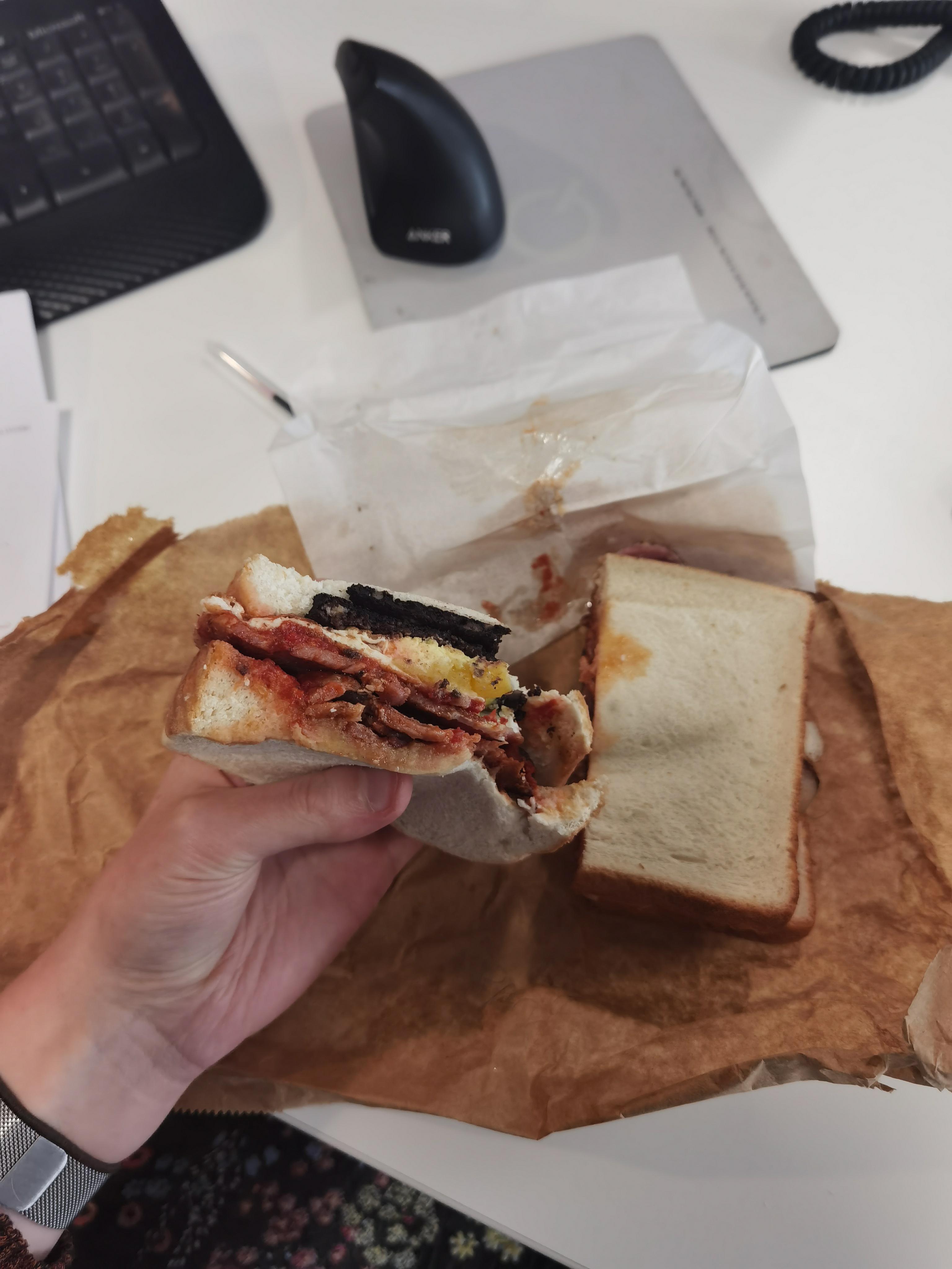 Fresh tomato, black pudding, fried egg and bacon on doorstop bread