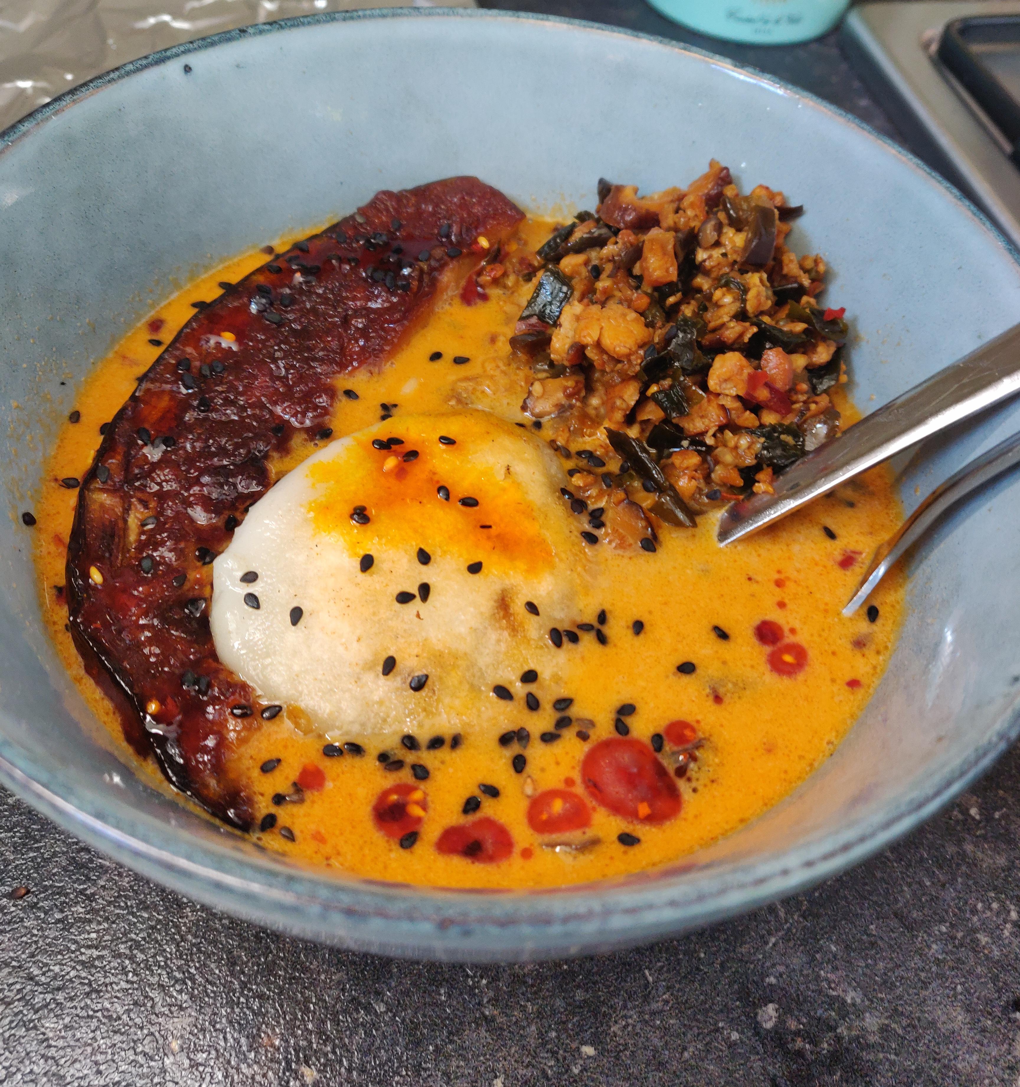 Homemade spicy shiitake ramen with miso glazed eggplant and stuffed