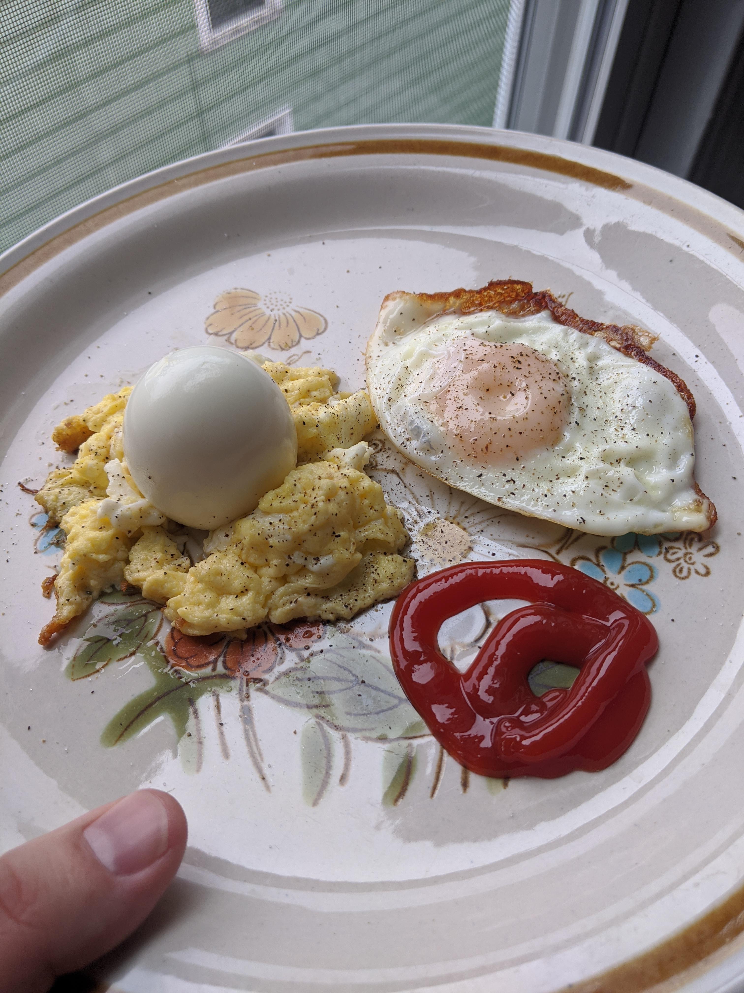 Hard boiled egg on a bed of scrambled egg with a sunny side of egg! r