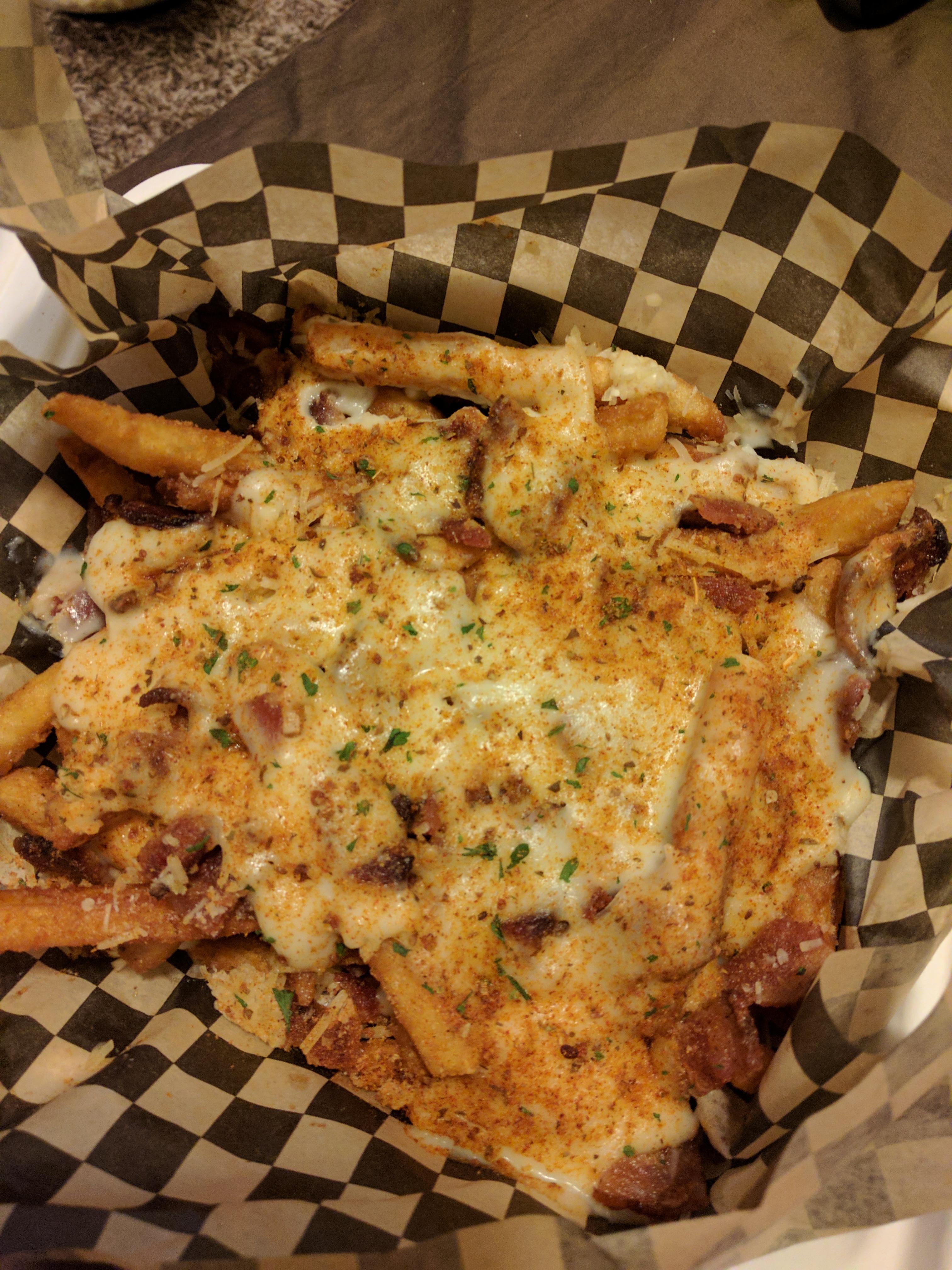 [I ate] Cheesy fries covered in bacon, garlic, parmesan, and a Cajun