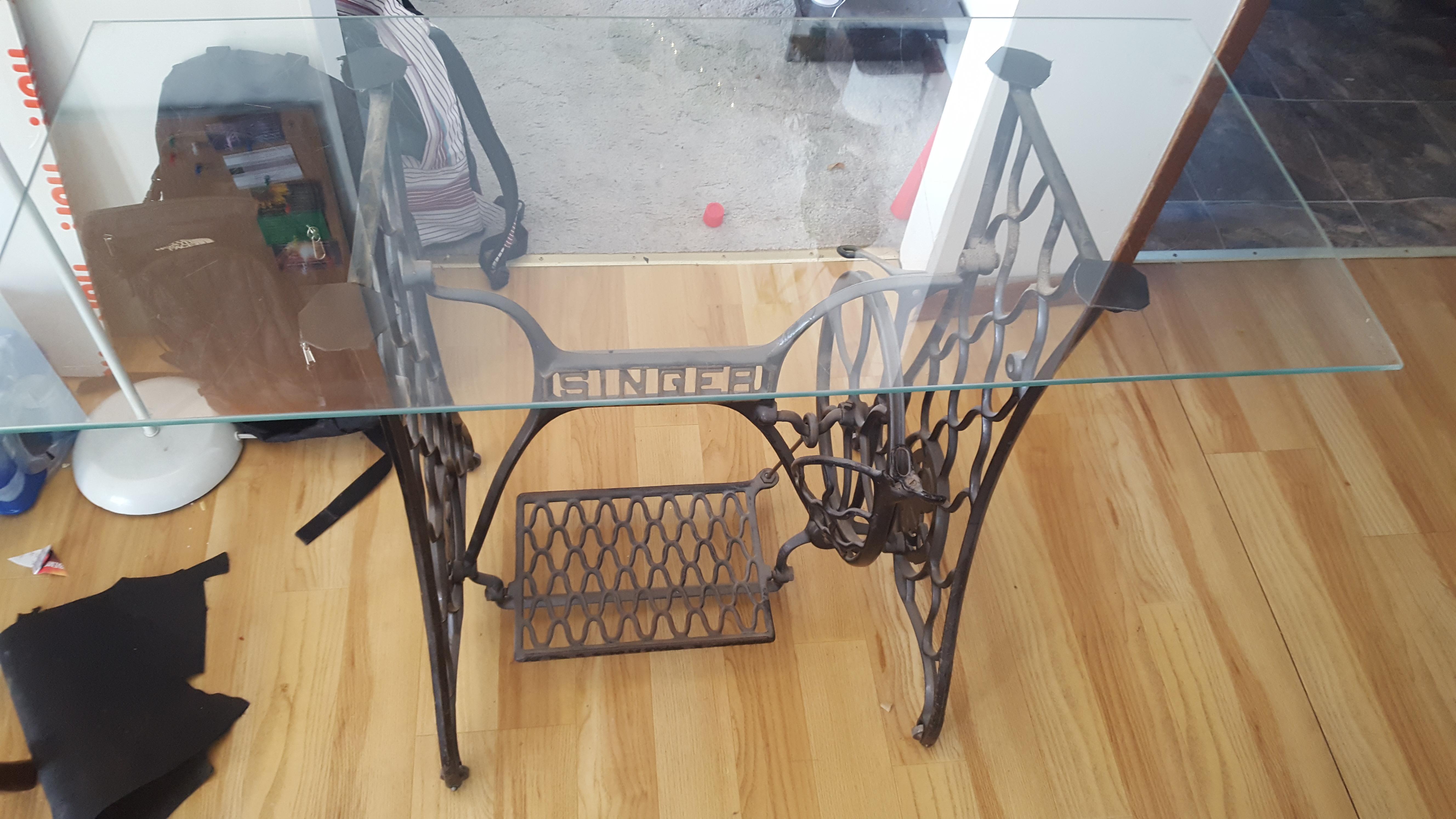 I made this glass top table out of coffee glass top and old singer