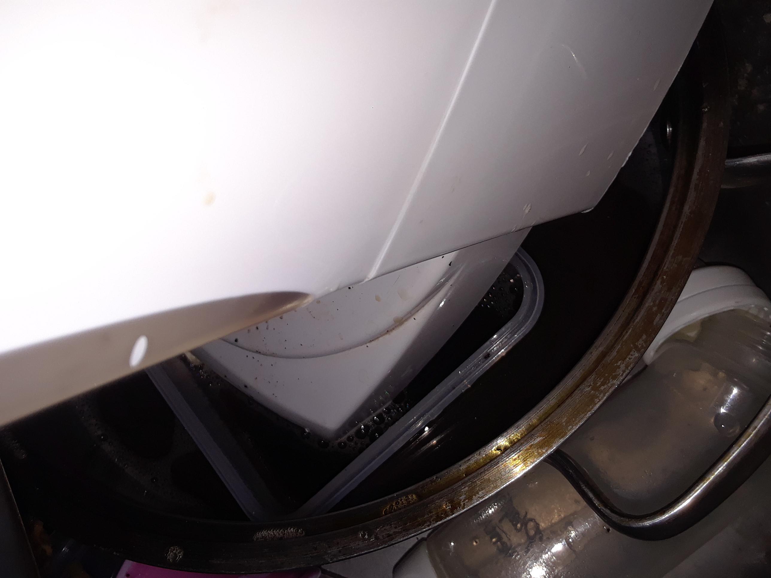 Person submerged part of bottom of coffee maker in water in sink(cord