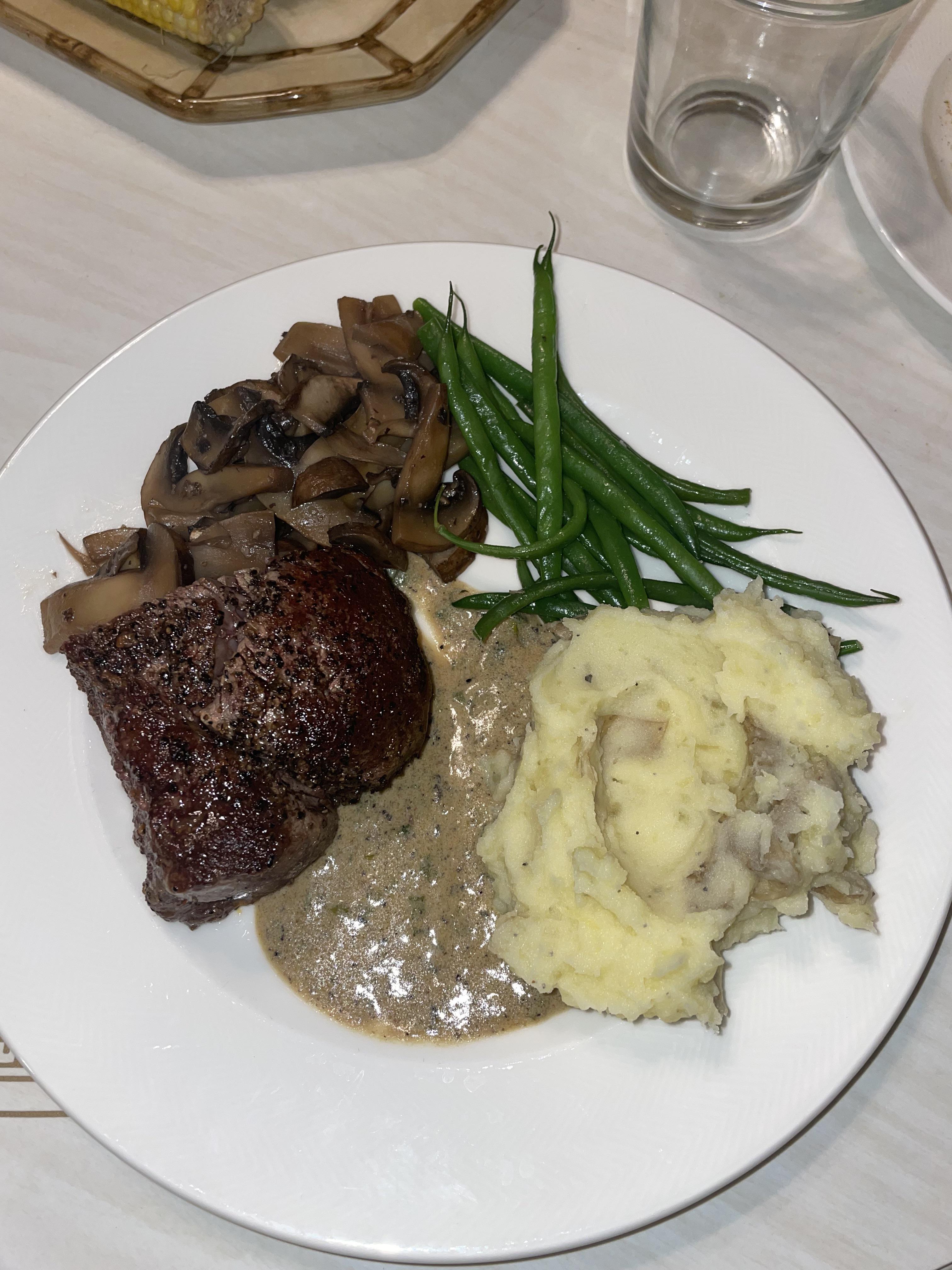 panseared & oven finished fillet mignon steak au poivre with sautéed