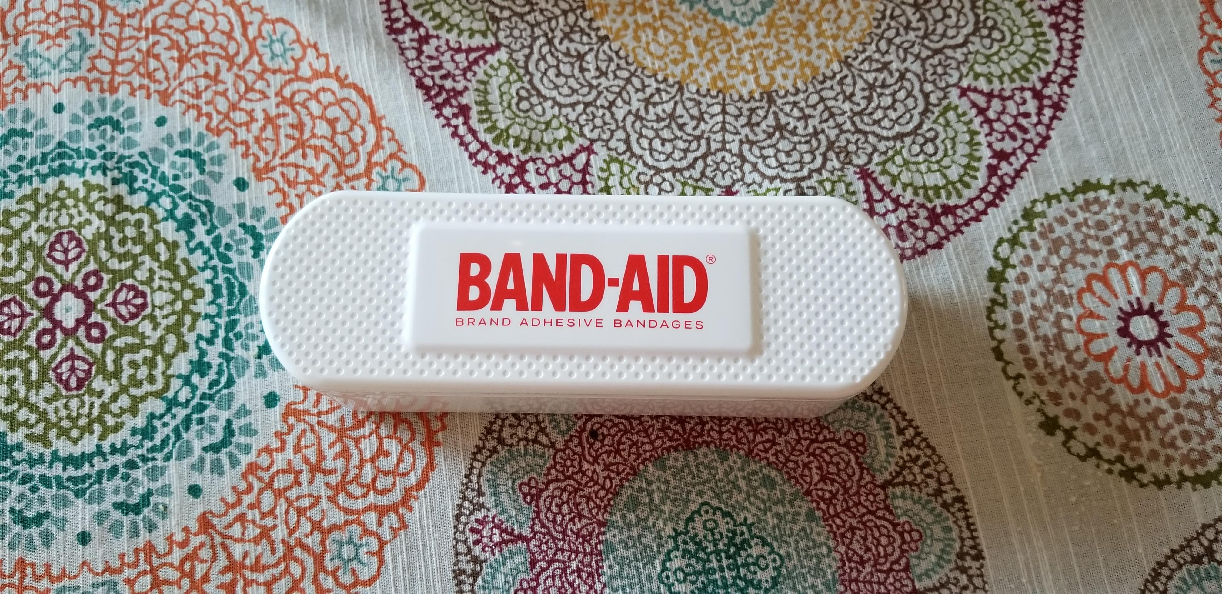 This bandaid container is in the shape of a bandaid. r
