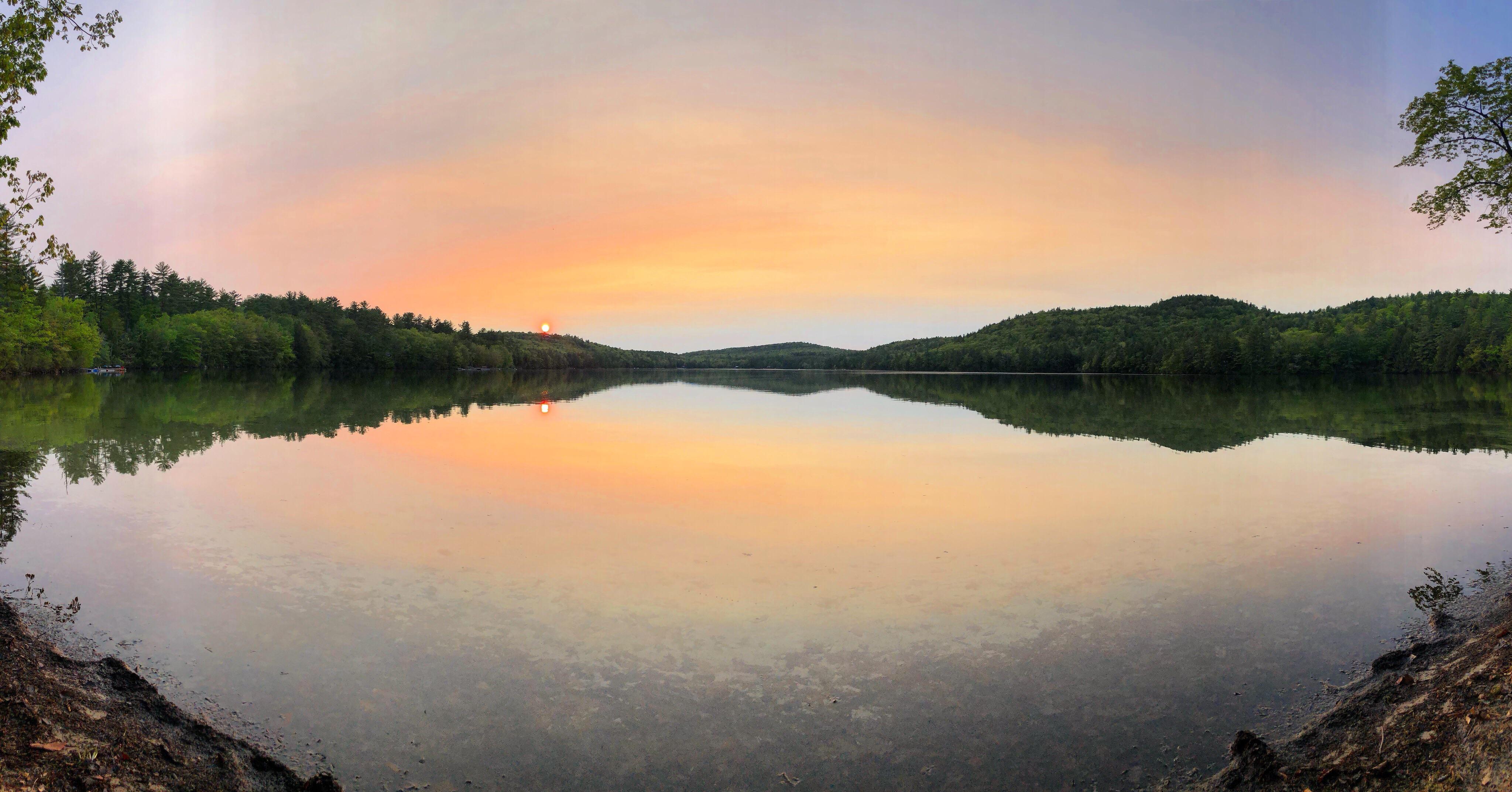 The sun setting over Long Pond in Cornish, Maine, USA. r/pics