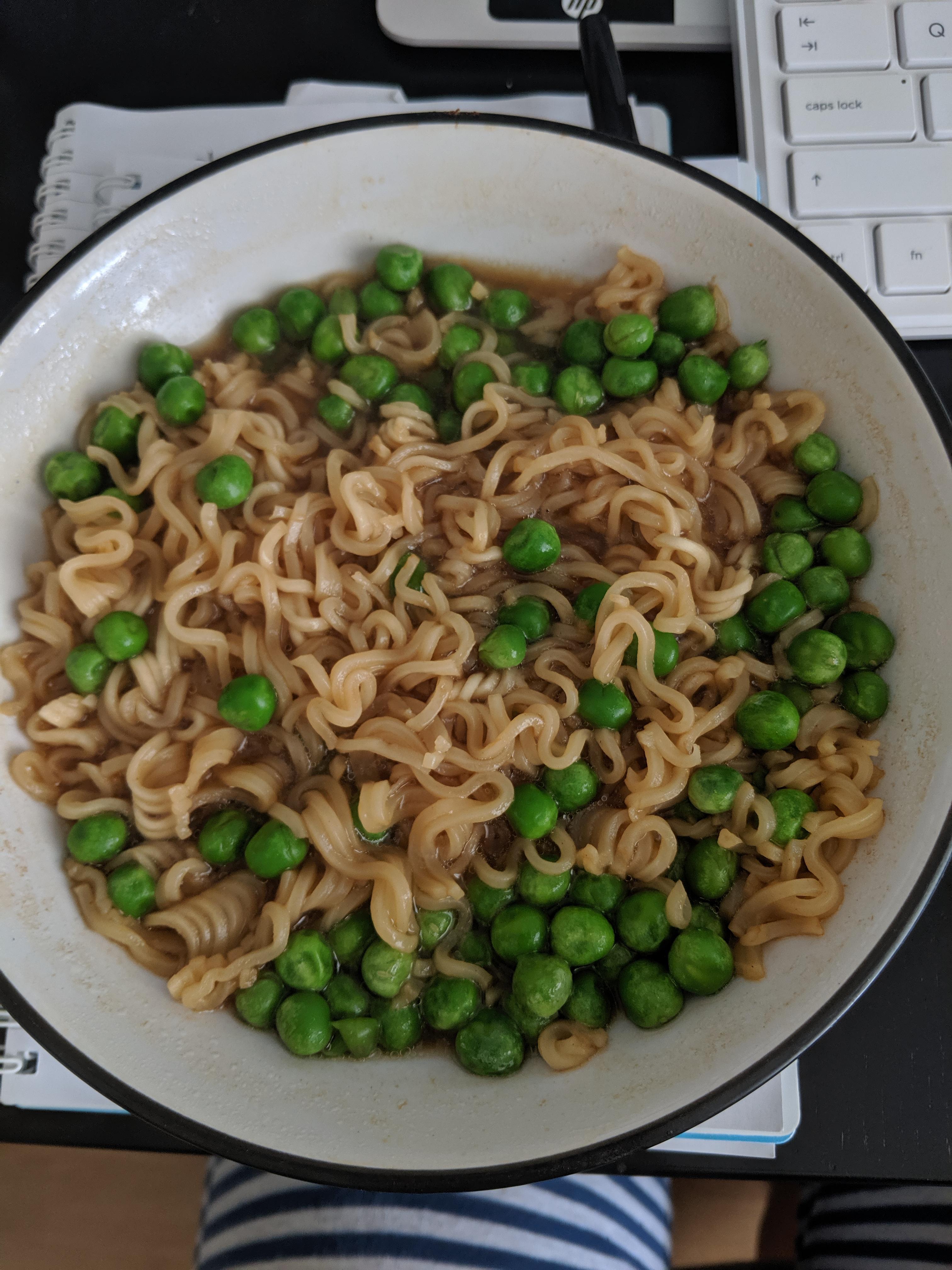 Instant chow mein flavour noodles with frozen peas stirred in r