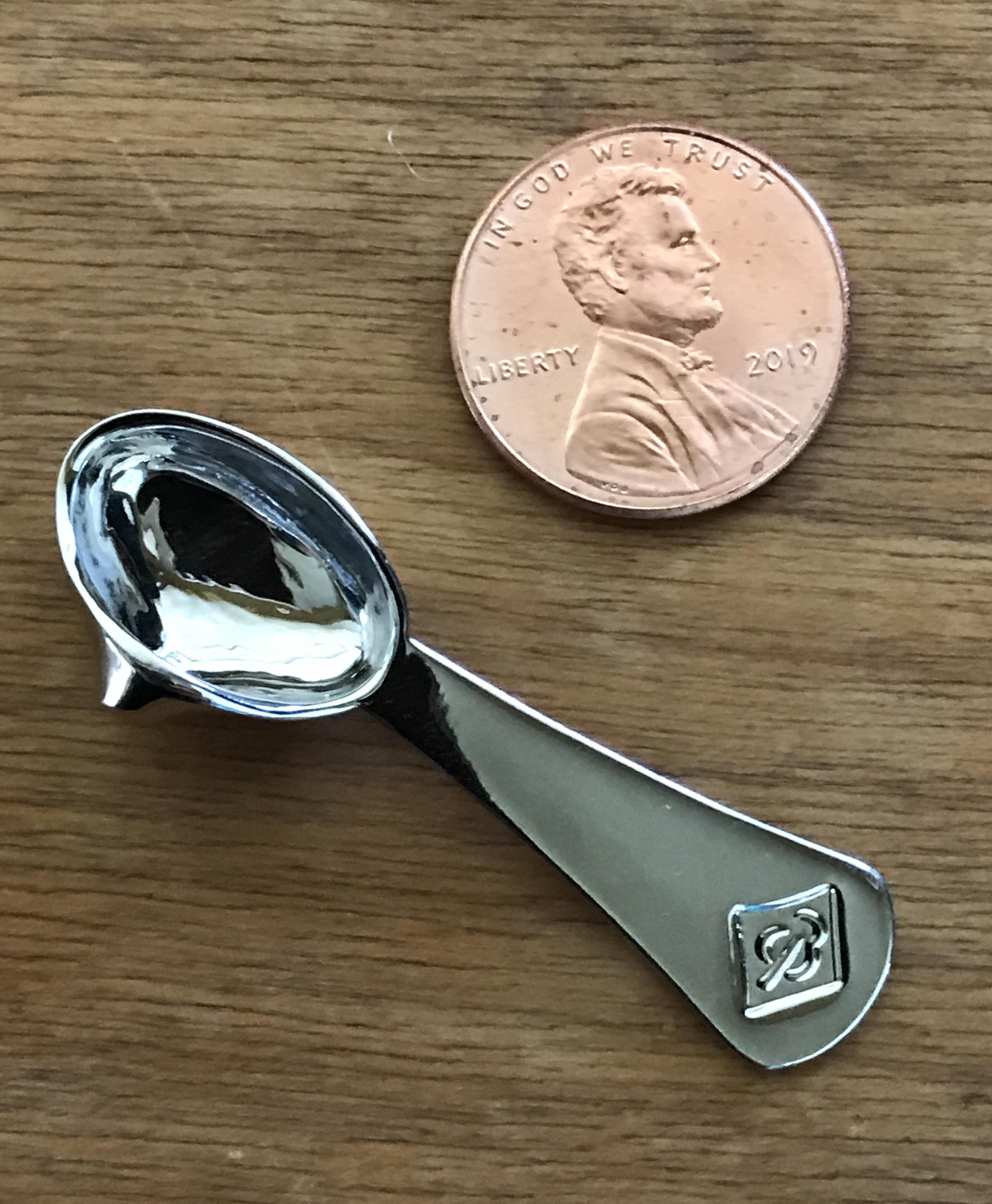 A tiny spoon with a funnel edge used to place cremated human remains