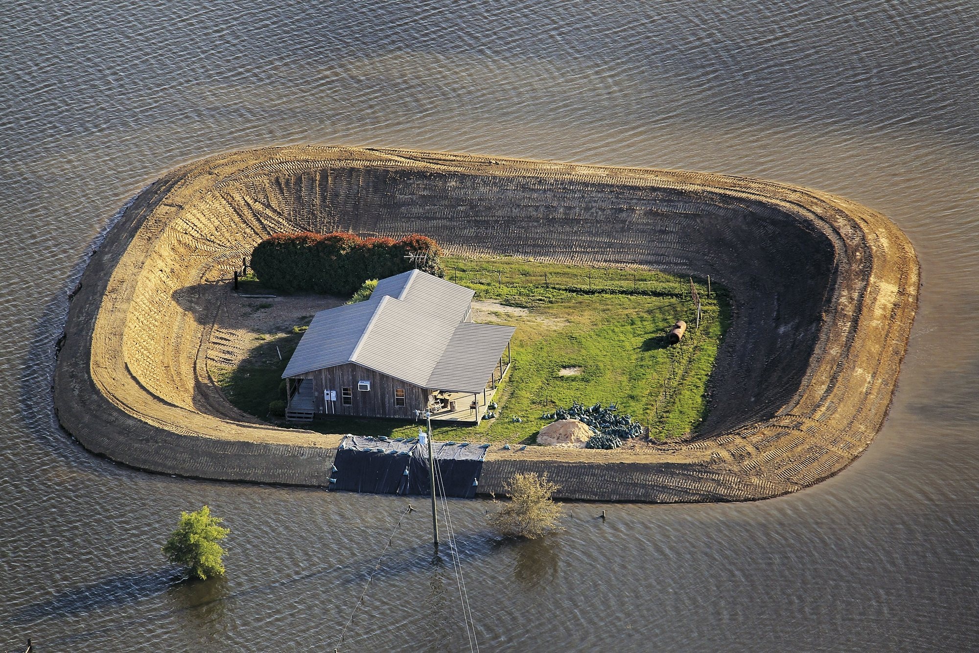 Fortified by a levee, a house near Vicksburg survives a Yazoo River