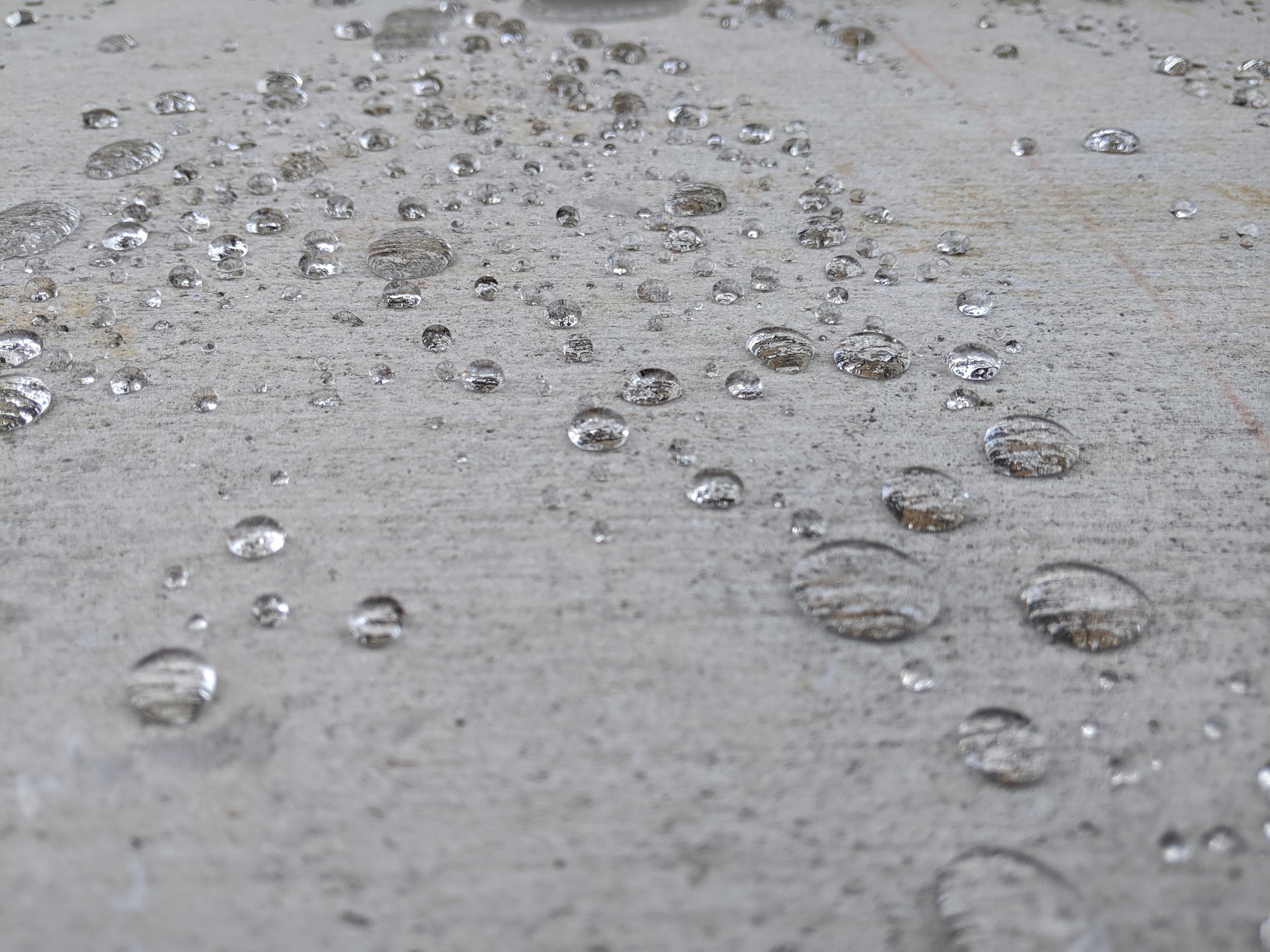 These rain drops sitting on the top of new concrete. r/oddlysatisfying