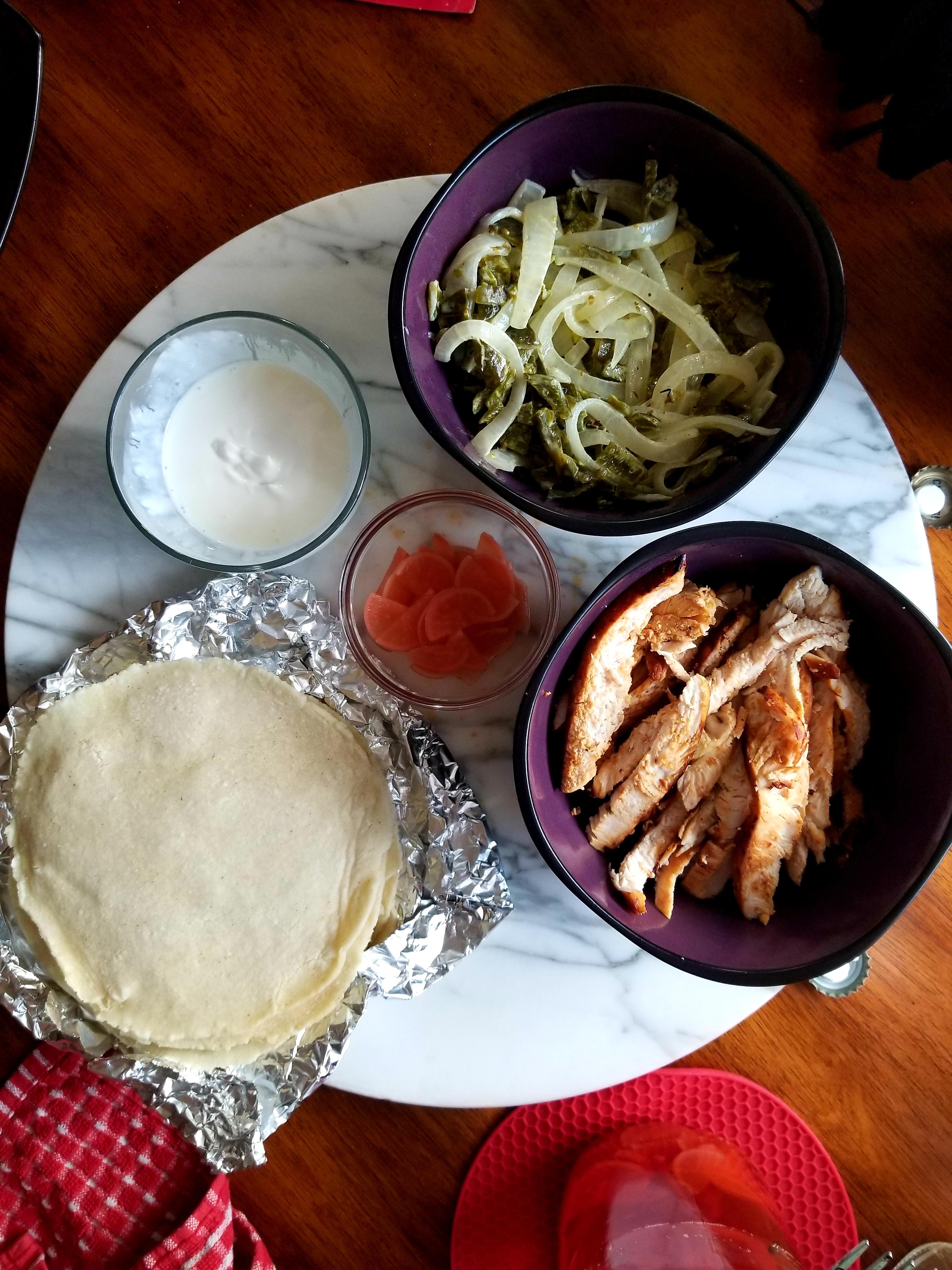 Chicken tacos with pickled radishes, rajas con crema, and corn
