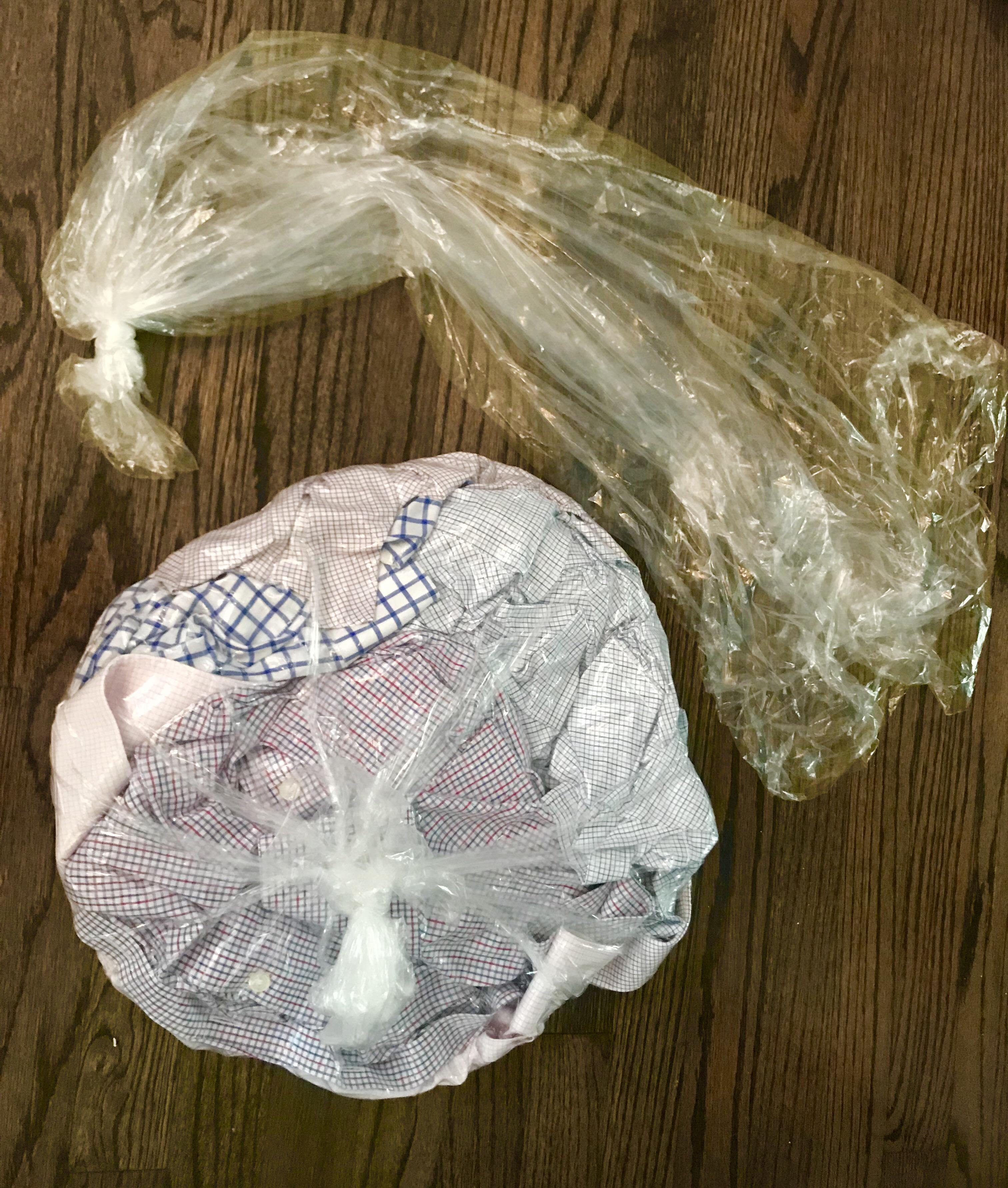 Tie a knot at the end of your dry cleaning plastic to make a bag for