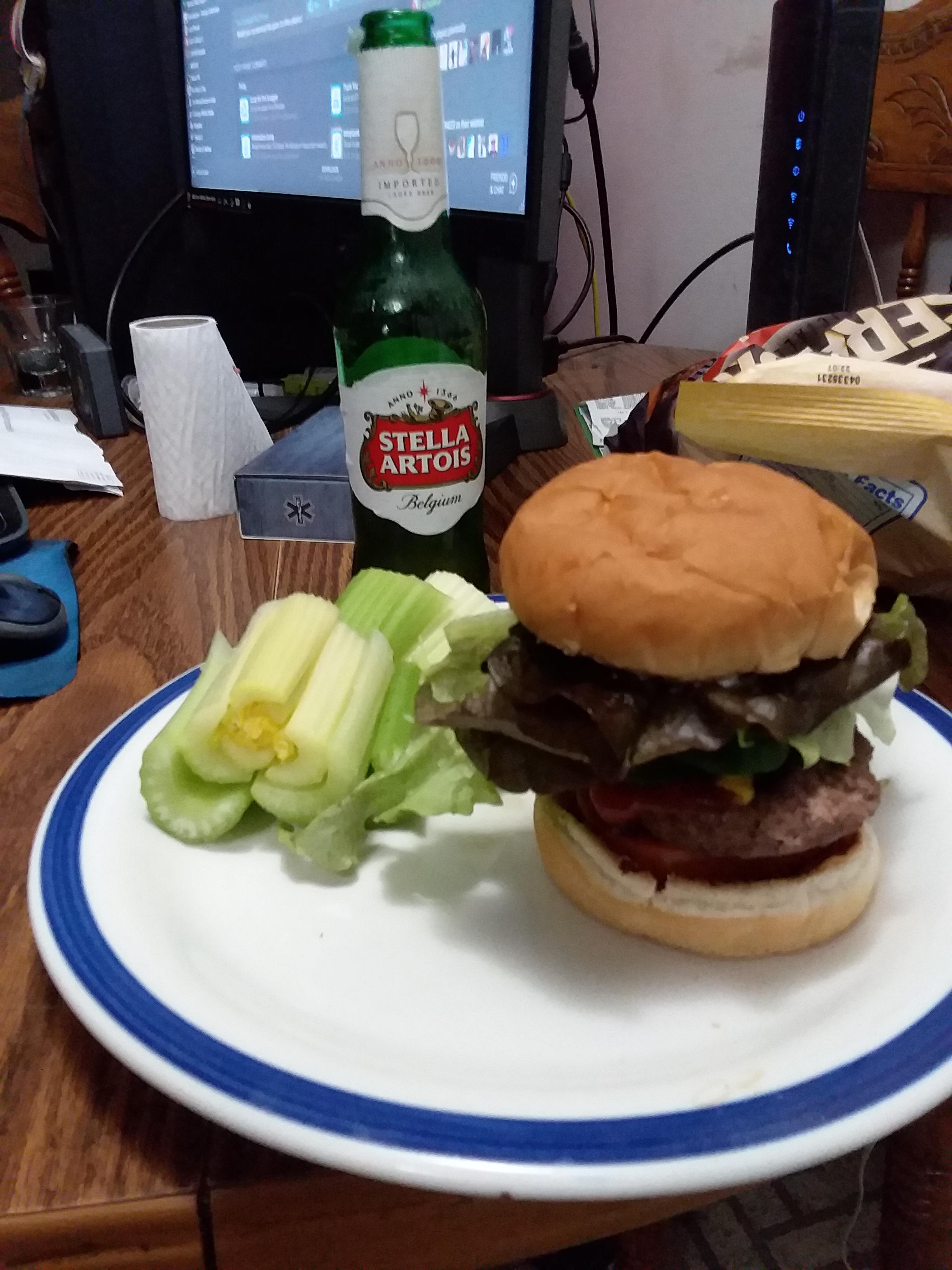 Burger with red leaf lettuce, cucumber, jalapeno and tomato with celery
