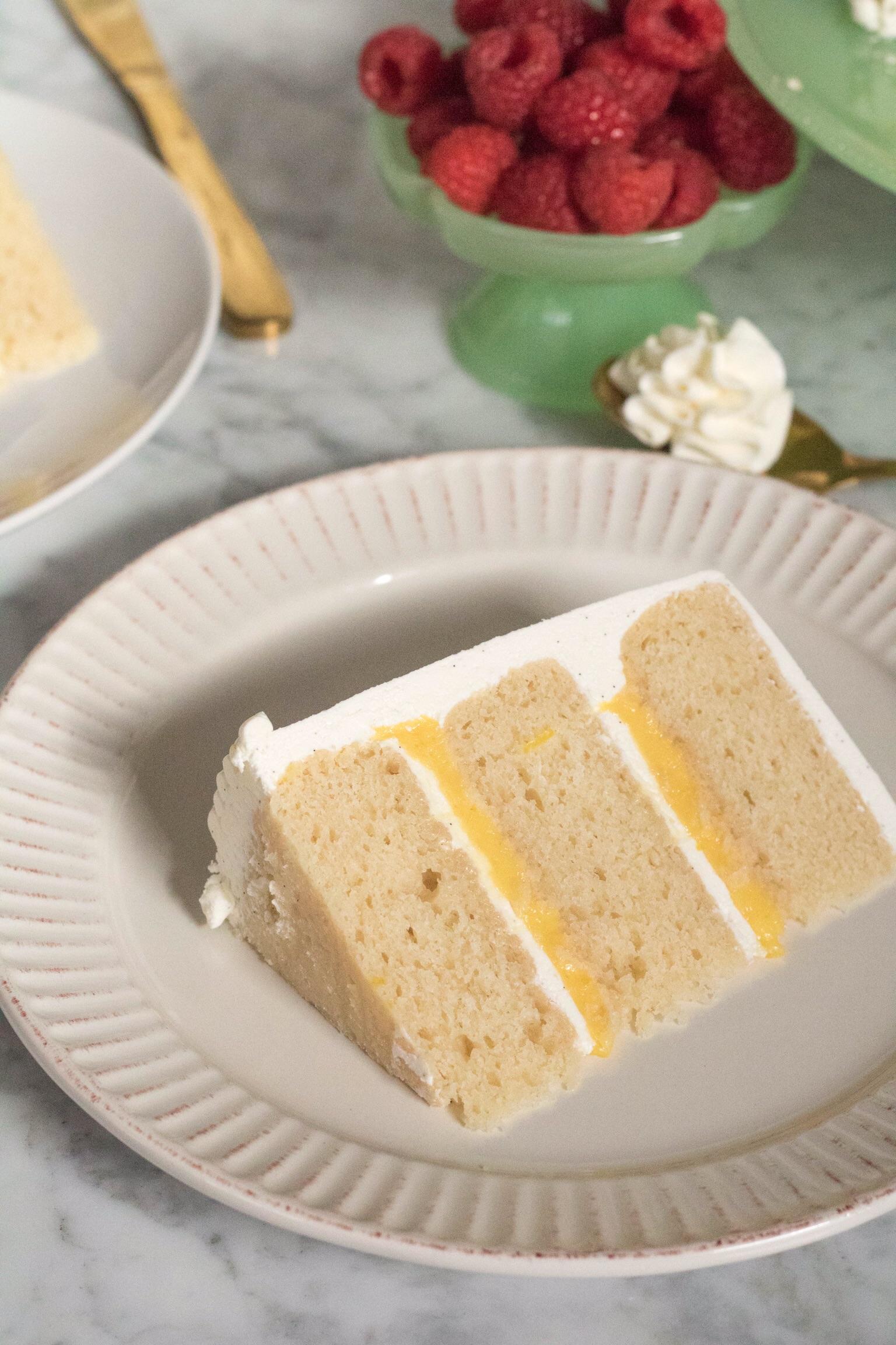 Slice of the layered vanilla cake with lemon curd filling and Italian