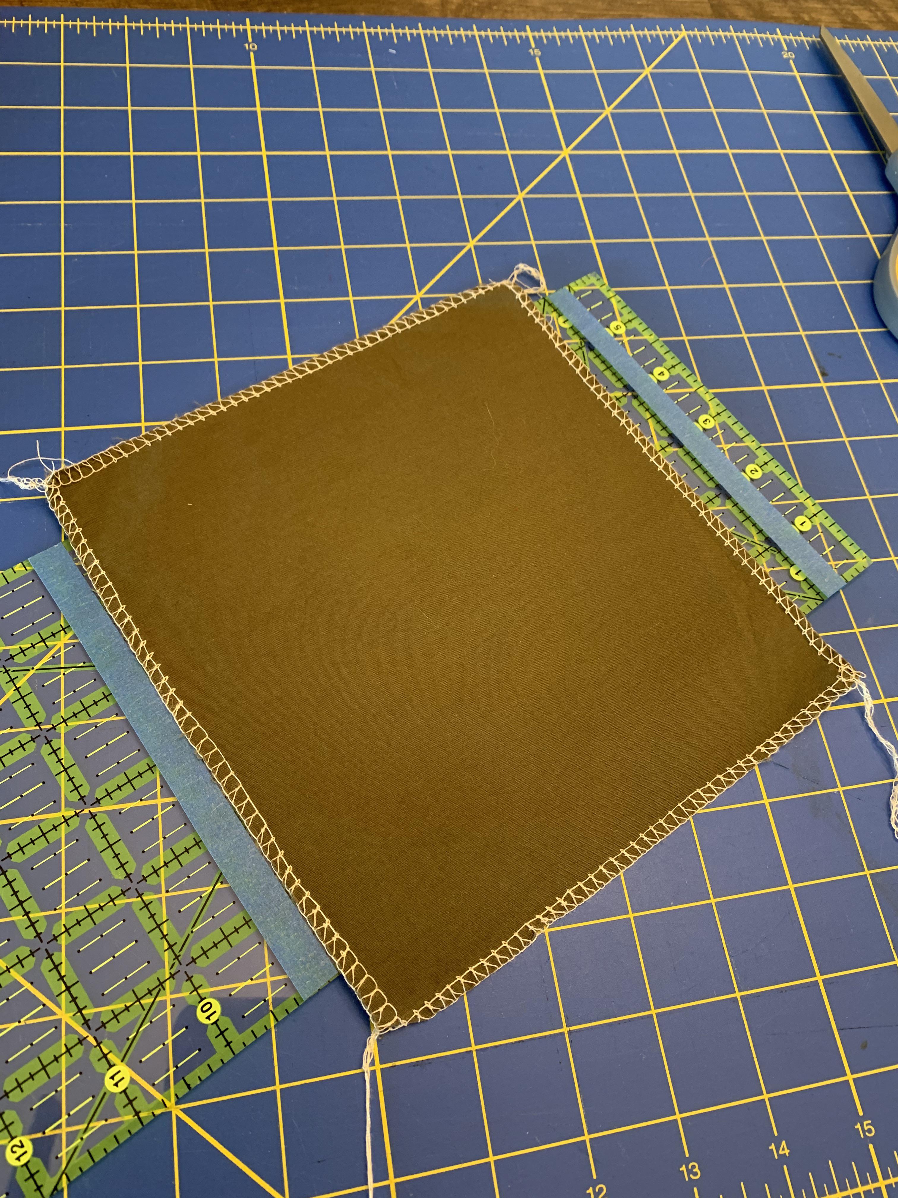 Visual of how much fabric shrinks 1/2” over 7 3/4” square or 6.4 r