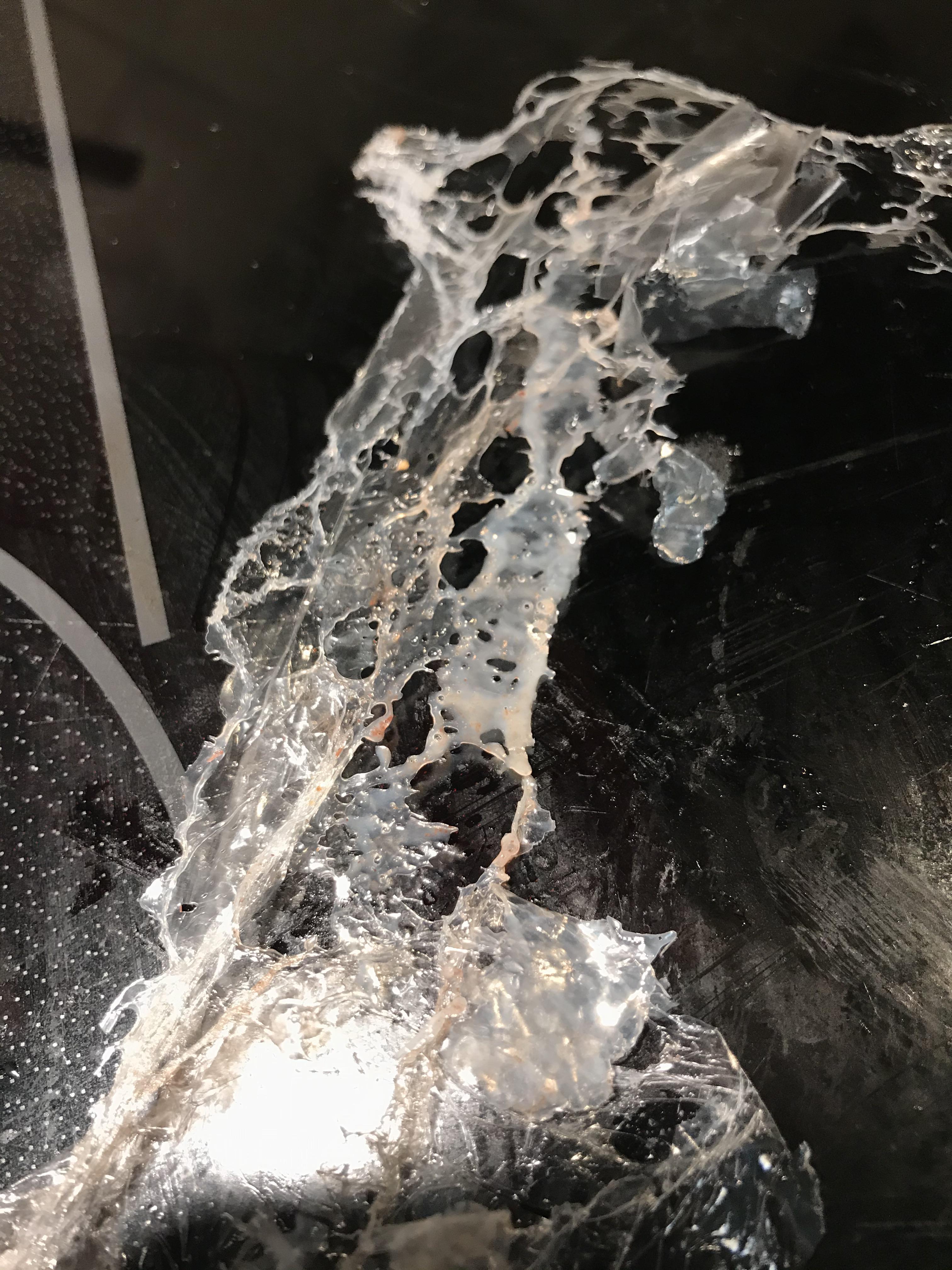 A piece of plastic wrap left on top of a toaster oven, melting and