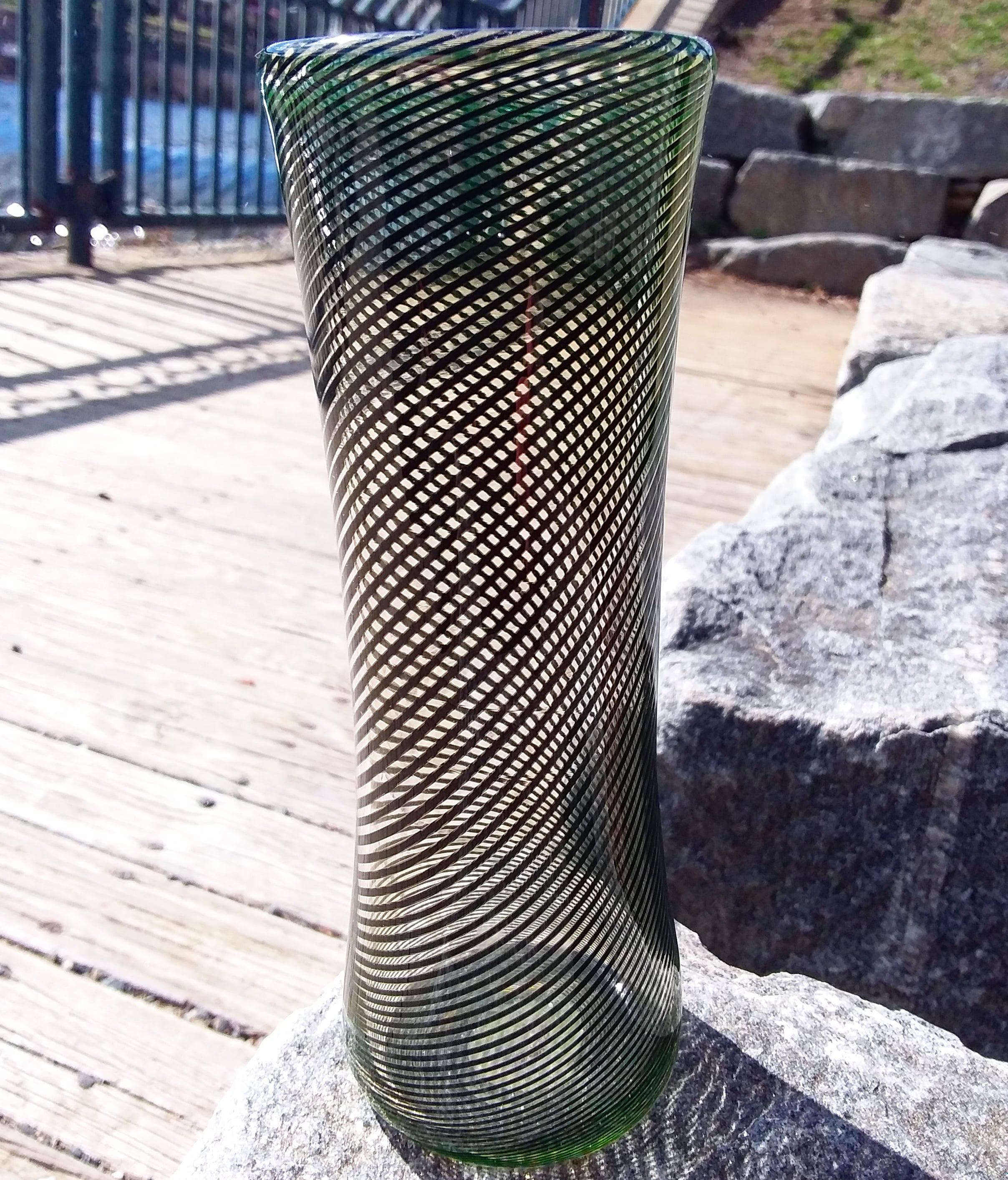 Blown glass uranium oxide cane vase I made, which means it glows under