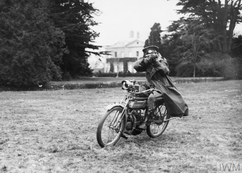 An Australian dispatch rider firing a rifle on a motorcycle during