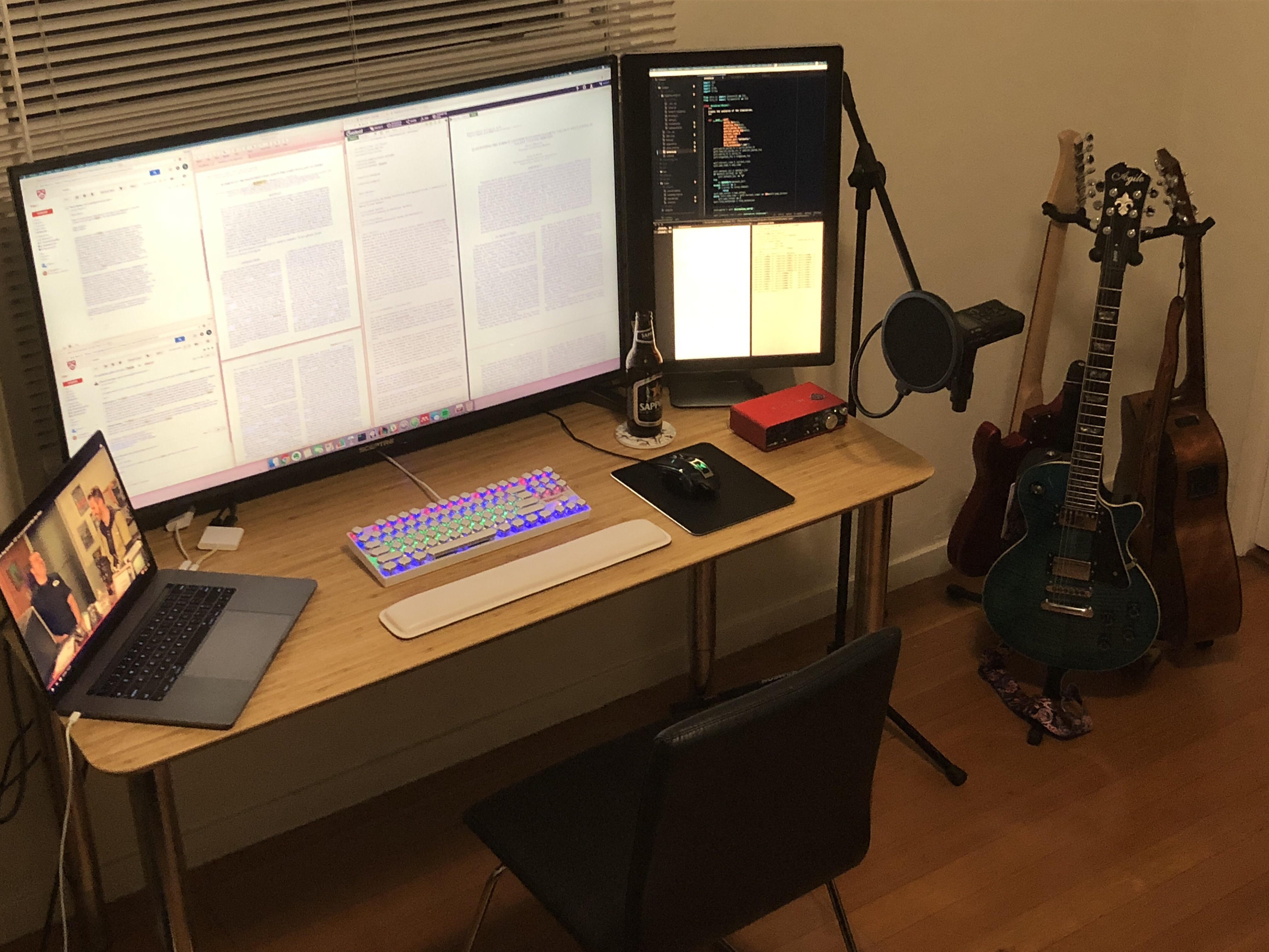 Astrophysics grad student setup — tons of screen real estate for papers