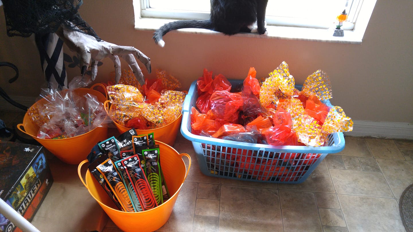 Trick or treat goody bags with toys and candy and glowsticks, the older