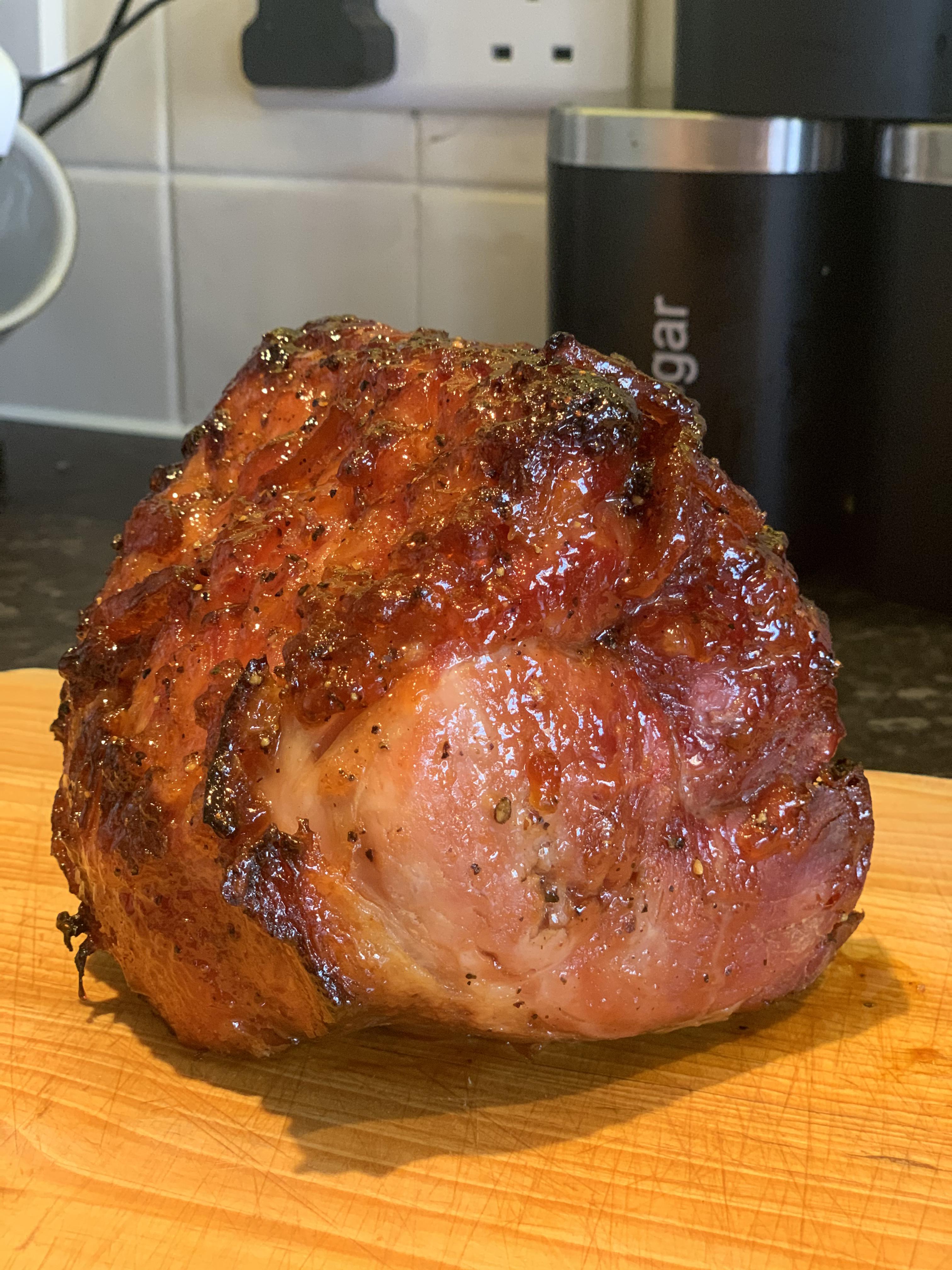 Marmalade and cracked black pepper glazed roast gammon ready for dinner