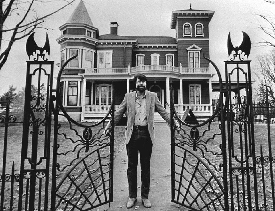 Stephen King standing at the gate of his house in Bangor, Maine. 1982