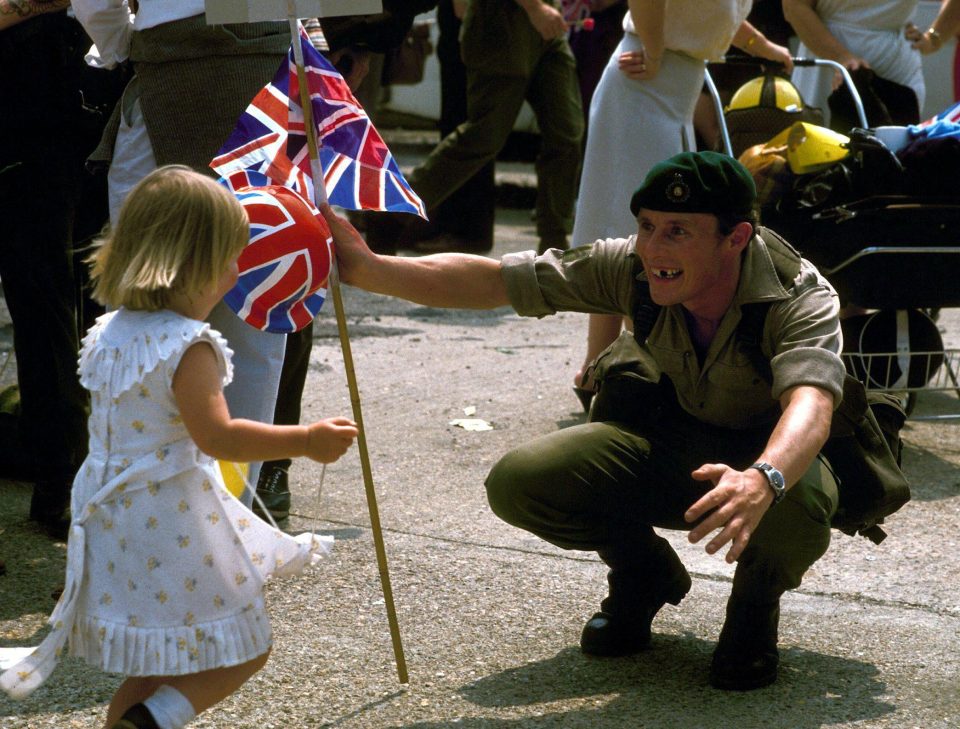 A Royal Marine greets his young daughter on his return from the