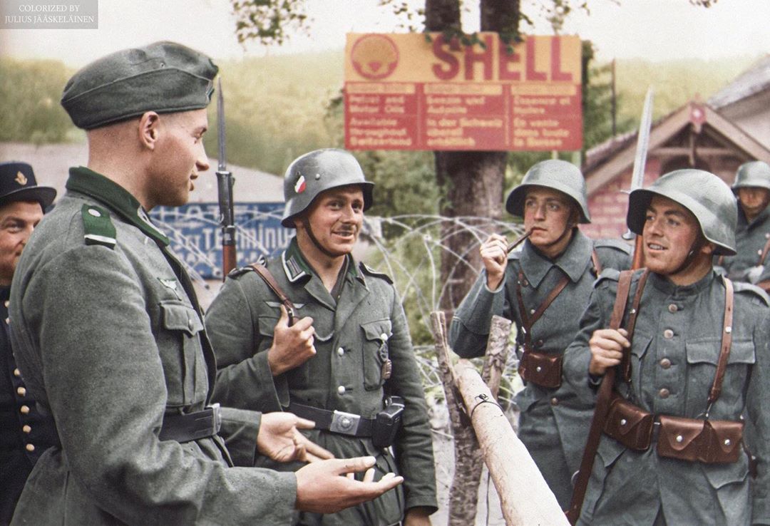 Colorized photo of German and Swiss soldier in conversation at the