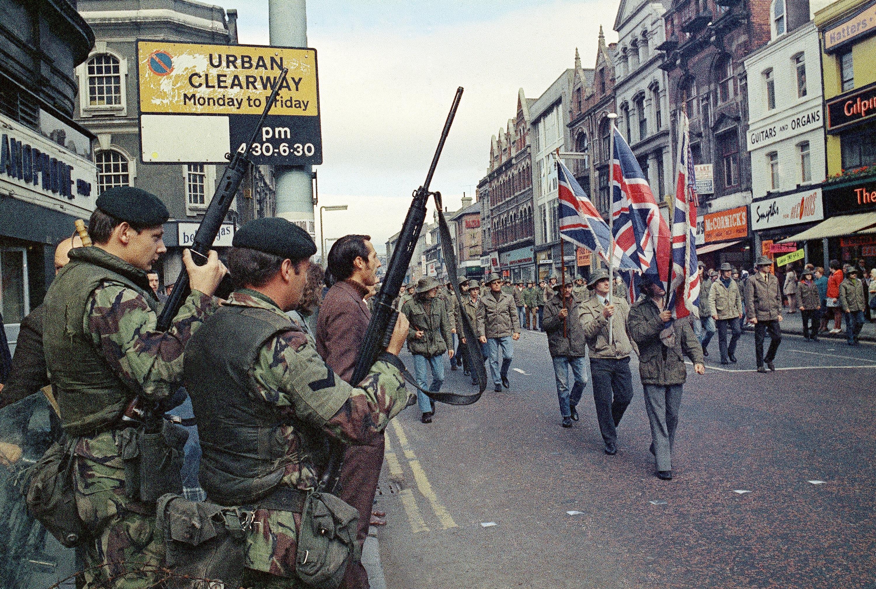 “Under the watchful eyes of armed British troops, members of the Ulster