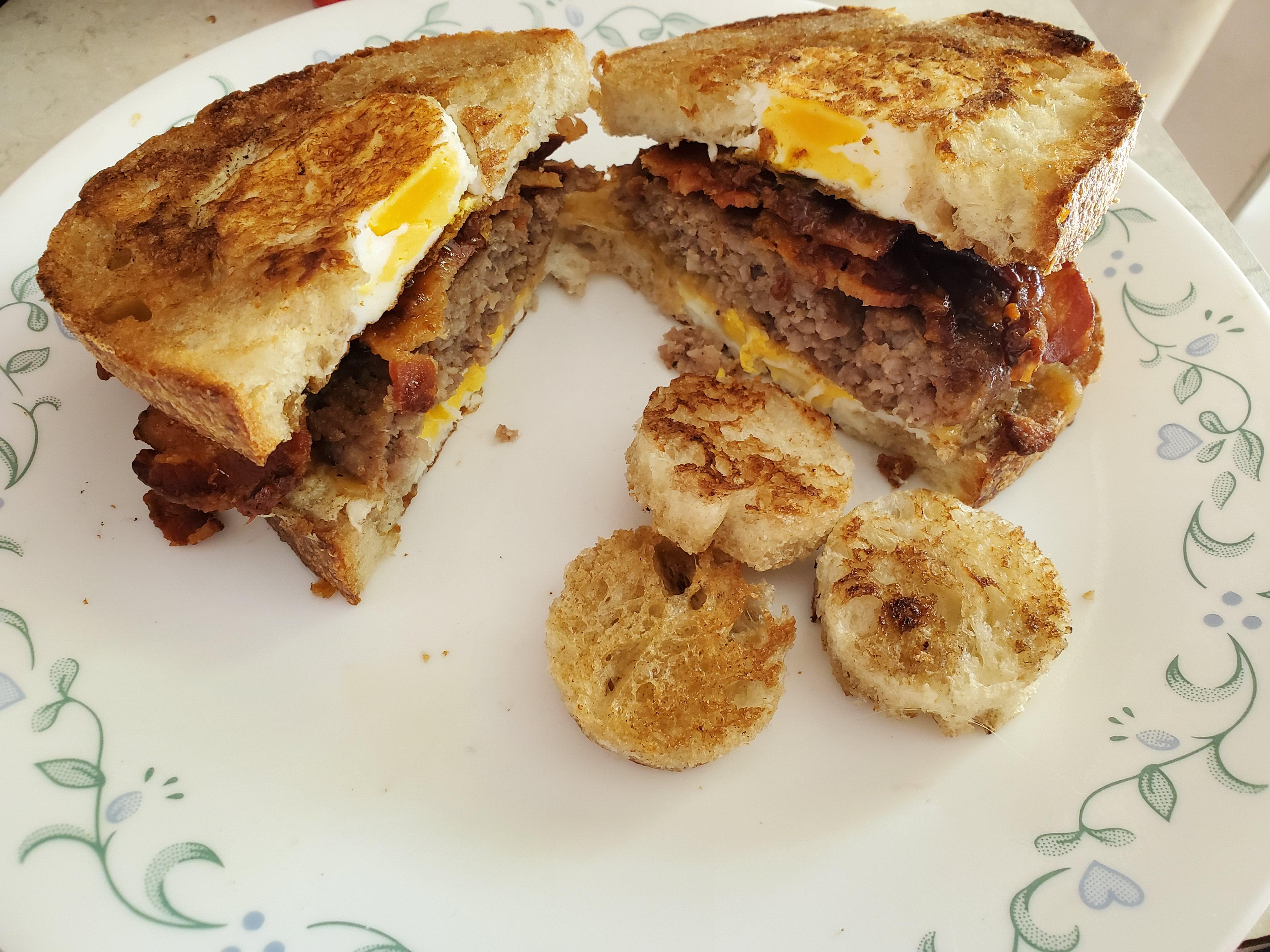 [Homemade] Egg in a nest sandwich with bacon, sausage, cheddar, and