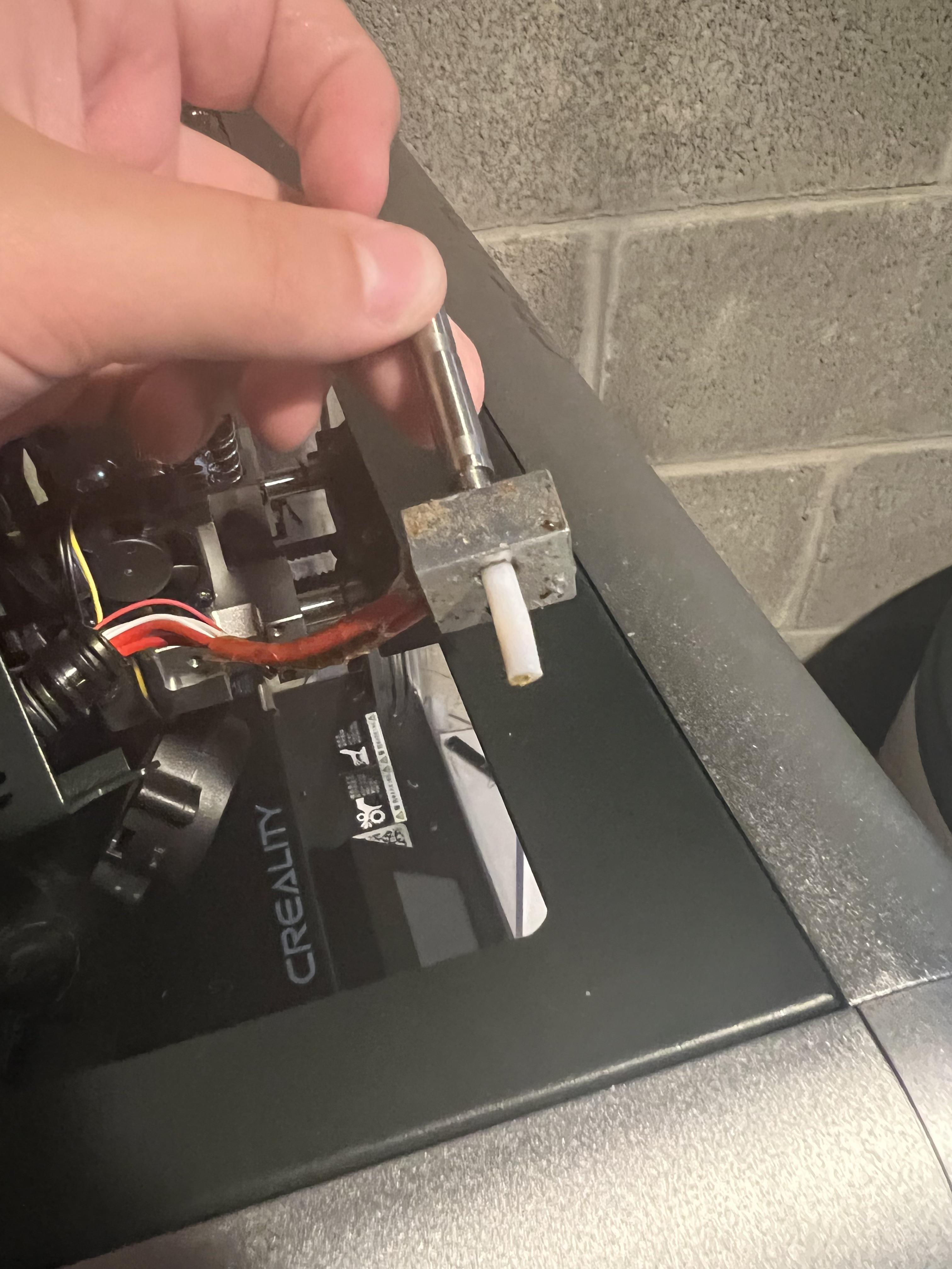 Trying to unclog printer and accidentally pushed out white tube. How do