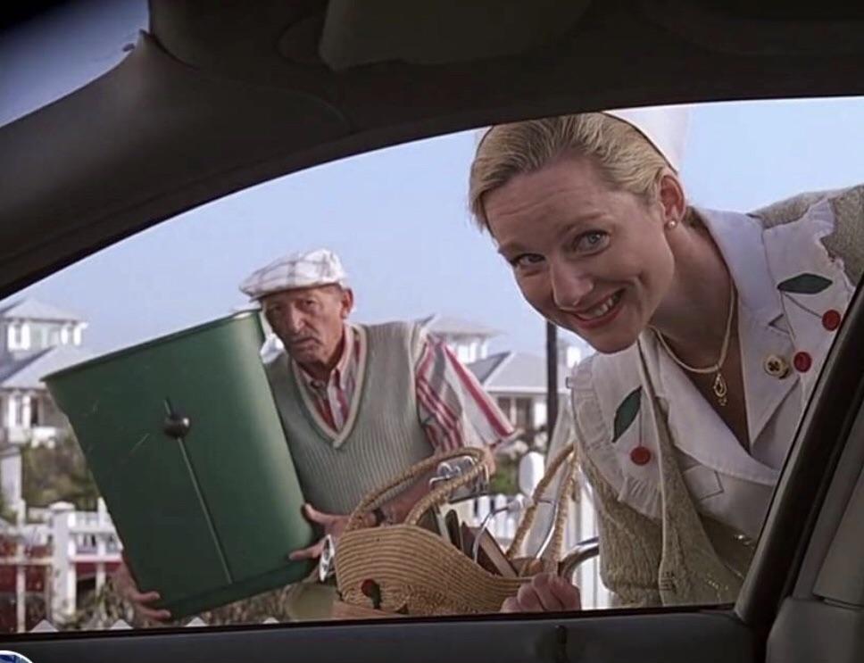In The Truman Show, Trumans neighbor holds up his garbage can that has