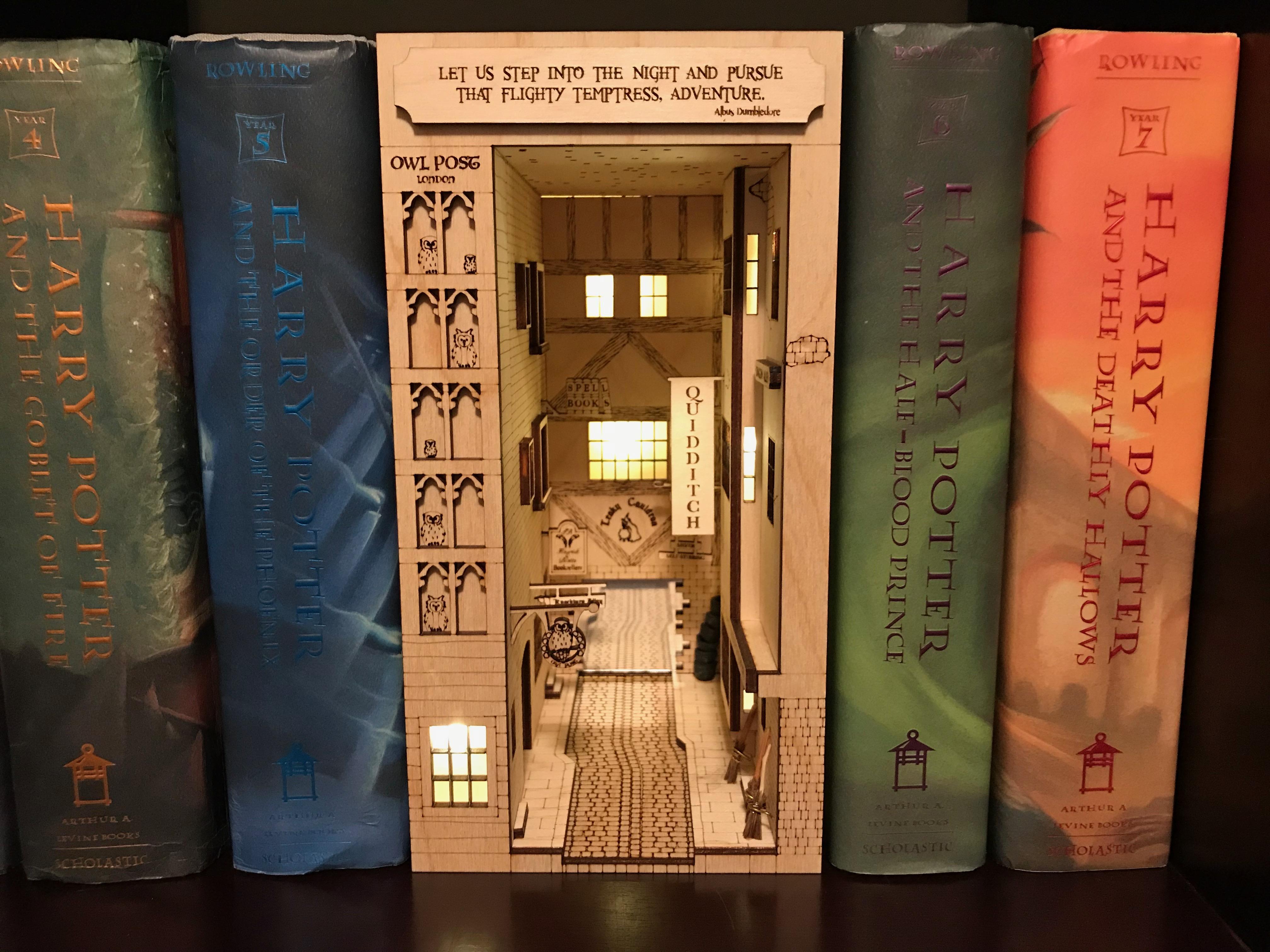 I made bookshelf art of Diagon Alley r/harrypotter